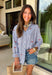 This blue and white stripe button down is the perfect blend of classic style and patriotic charm! Featuring embroidered American flags throughout, it adds a fun, festive touch while still feeling timeless and easy to wear. The collared neckline and button down design give it that effortless, polished look you can style for everything from backyard BBQs to fireworks and holiday weekends. Lightweight and breathable, it’s the perfect layer for all your summer celebrations. 
