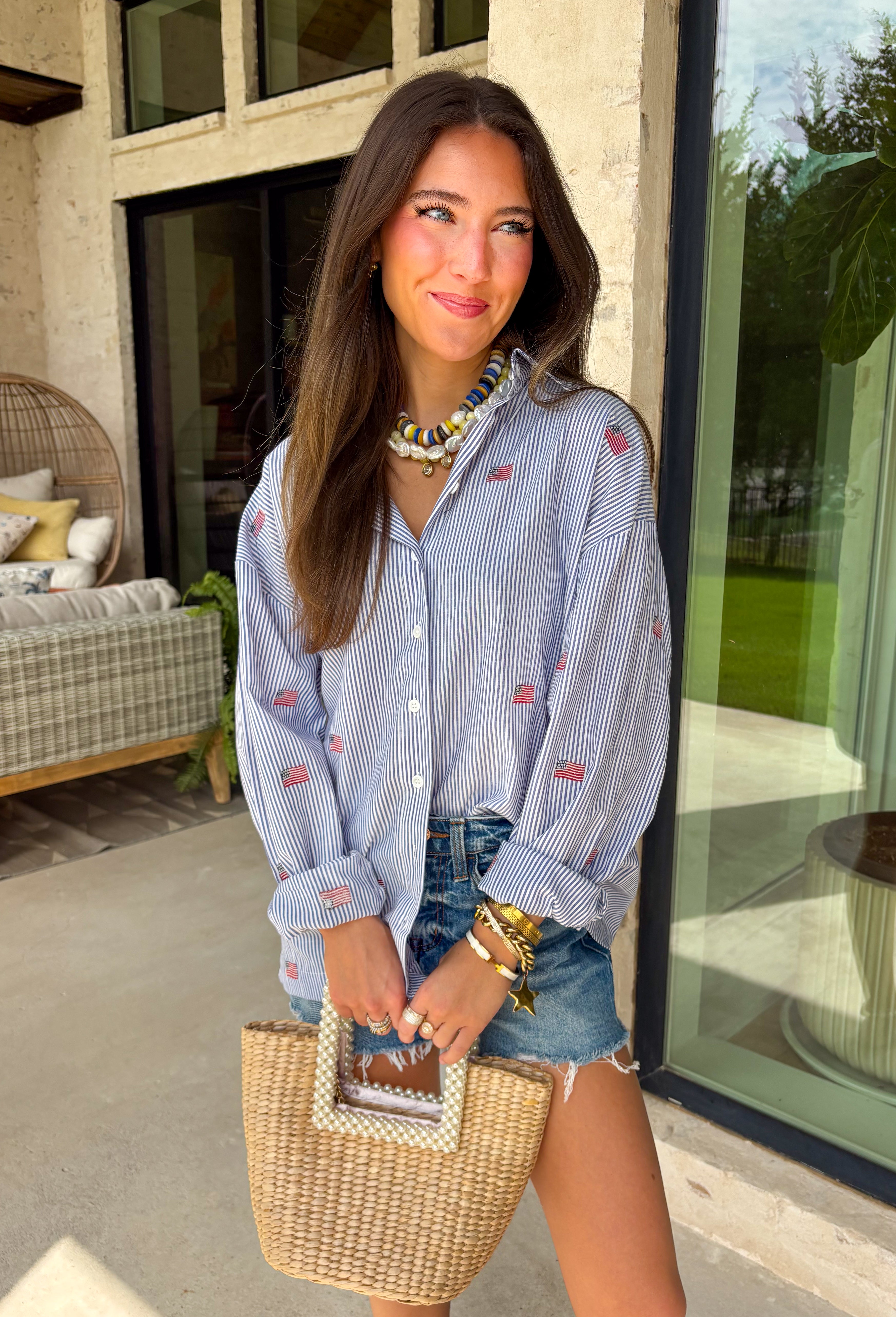 This blue and white stripe button down is the perfect blend of classic style and patriotic charm! Featuring embroidered American flags throughout, it adds a fun, festive touch while still feeling timeless and easy to wear. The collared neckline and button down design give it that effortless, polished look you can style for everything from backyard BBQs to fireworks and holiday weekends. Lightweight and breathable, it’s the perfect layer for all your summer celebrations. 