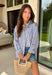 This blue and white stripe button down is the perfect blend of classic style and patriotic charm! Featuring embroidered American flags throughout, it adds a fun, festive touch while still feeling timeless and easy to wear. The collared neckline and button down design give it that effortless, polished look you can style for everything from backyard BBQs to fireworks and holiday weekends. Lightweight and breathable, it’s the perfect layer for all your summer celebrations. 