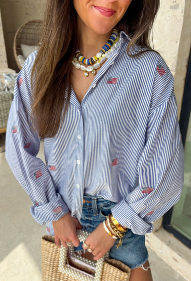 This blue and white stripe button down is the perfect blend of classic style and patriotic charm! Featuring embroidered American flags throughout, it adds a fun, festive touch while still feeling timeless and easy to wear. The collared neckline and button down design give it that effortless, polished look you can style for everything from backyard BBQs to fireworks and holiday weekends. Lightweight and breathable, it’s the perfect layer for all your summer celebrations. 
