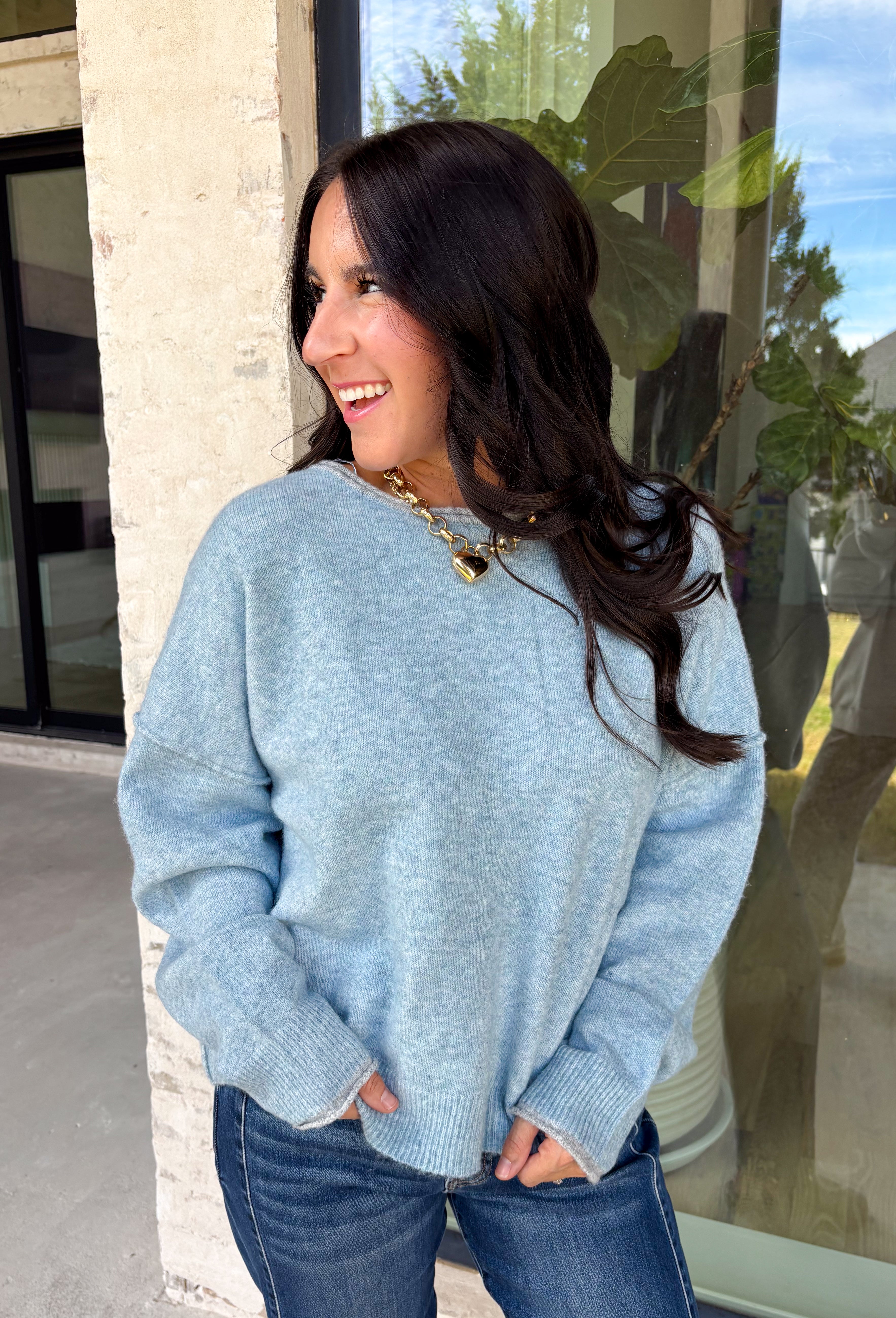 Wrap yourself in everyday comfort with this cozy sweater from Hyfve. Designed in a soft light blue hue, this timeless knit is elevated with a contrasting gray neckline for a subtle touch of detail. Exposed seam accents give it a relaxed, lived-in feel, while the ribbed hem and cuffs create a classic finish. Crafted from an ultra-soft knit, this versatile sweater is perfect for layering on crisp fall mornings or wearing on its own throughout the season.