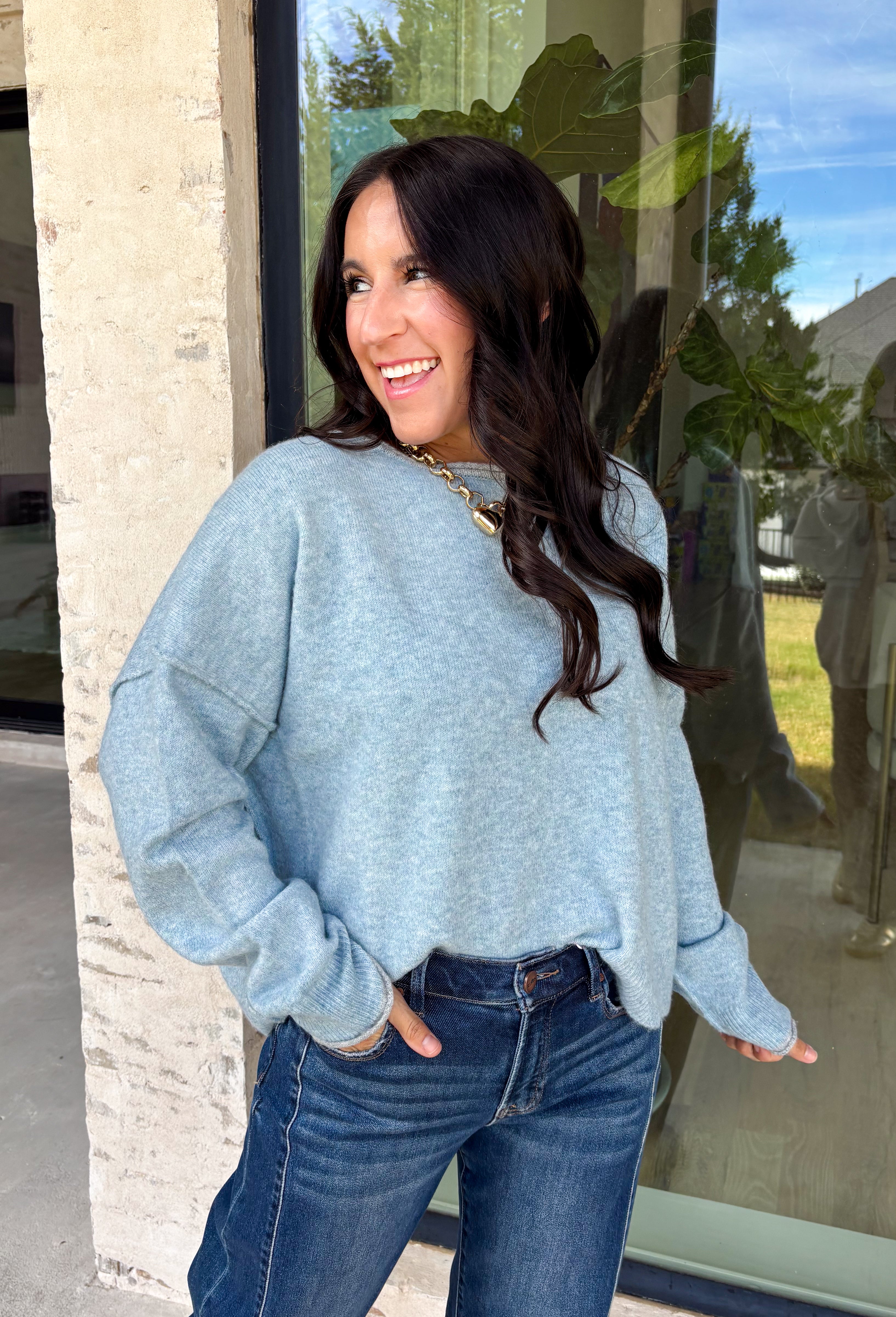 Wrap yourself in everyday comfort with this cozy sweater from Hyfve. Designed in a soft light blue hue, this timeless knit is elevated with a contrasting gray neckline for a subtle touch of detail. Exposed seam accents give it a relaxed, lived-in feel, while the ribbed hem and cuffs create a classic finish. Crafted from an ultra-soft knit, this versatile sweater is perfect for layering on crisp fall mornings or wearing on its own throughout the season.