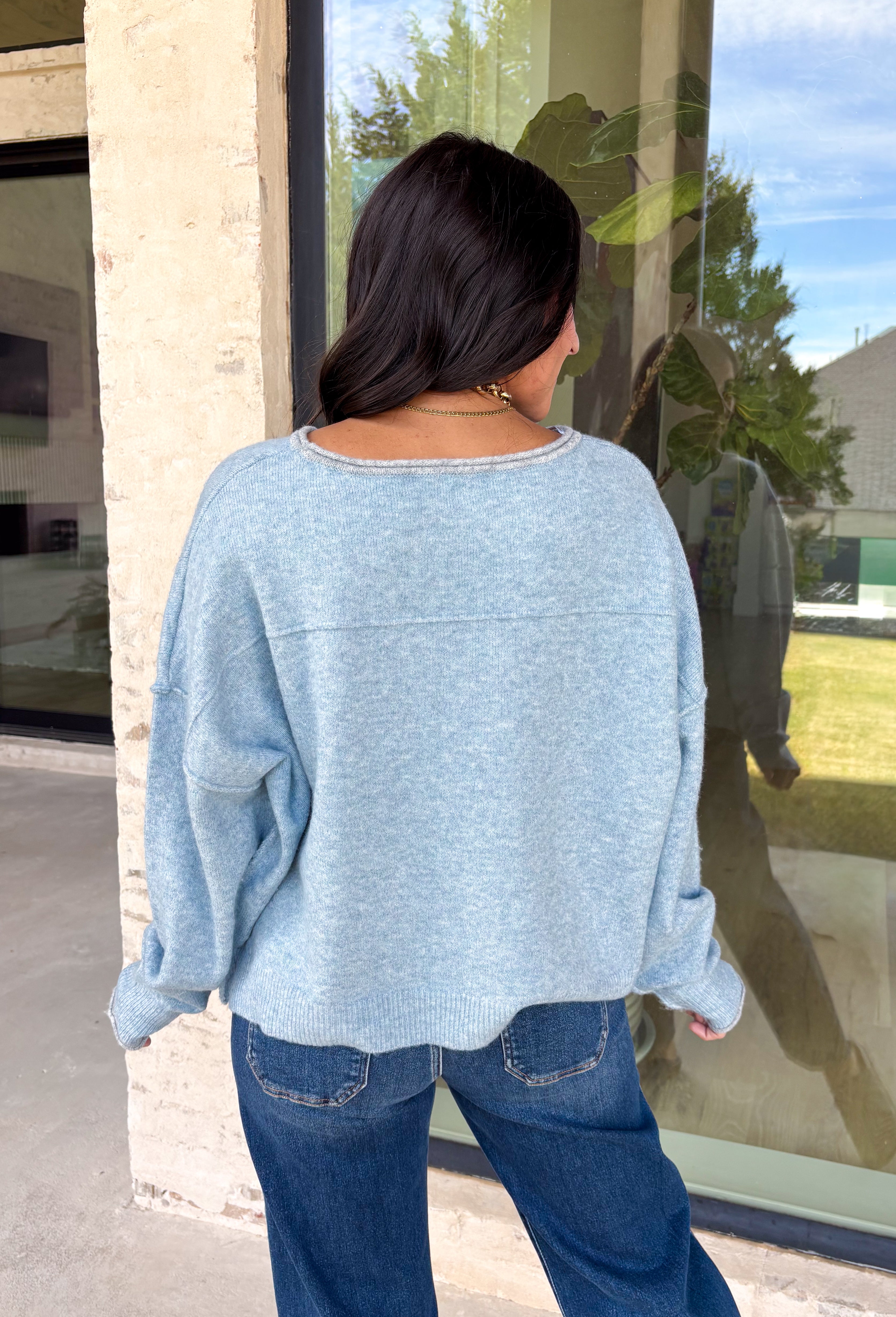 Wrap yourself in everyday comfort with this cozy sweater from Hyfve. Designed in a soft light blue hue, this timeless knit is elevated with a contrasting gray neckline for a subtle touch of detail. Exposed seam accents give it a relaxed, lived-in feel, while the ribbed hem and cuffs create a classic finish. Crafted from an ultra-soft knit, this versatile sweater is perfect for layering on crisp fall mornings or wearing on its own throughout the season.