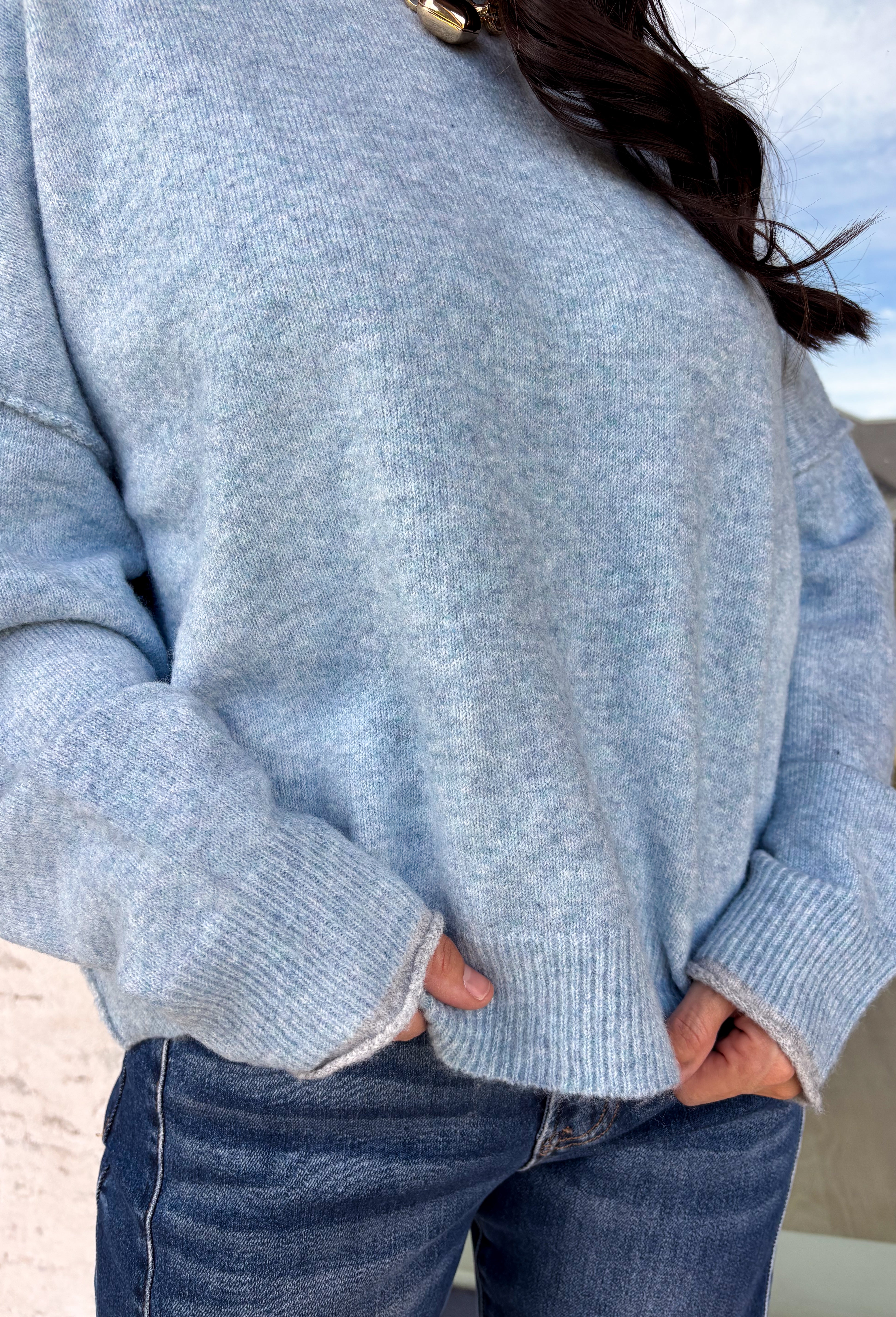 Wrap yourself in everyday comfort with this cozy sweater from Hyfve. Designed in a soft light blue hue, this timeless knit is elevated with a contrasting gray neckline for a subtle touch of detail. Exposed seam accents give it a relaxed, lived-in feel, while the ribbed hem and cuffs create a classic finish. Crafted from an ultra-soft knit, this versatile sweater is perfect for layering on crisp fall mornings or wearing on its own throughout the season.