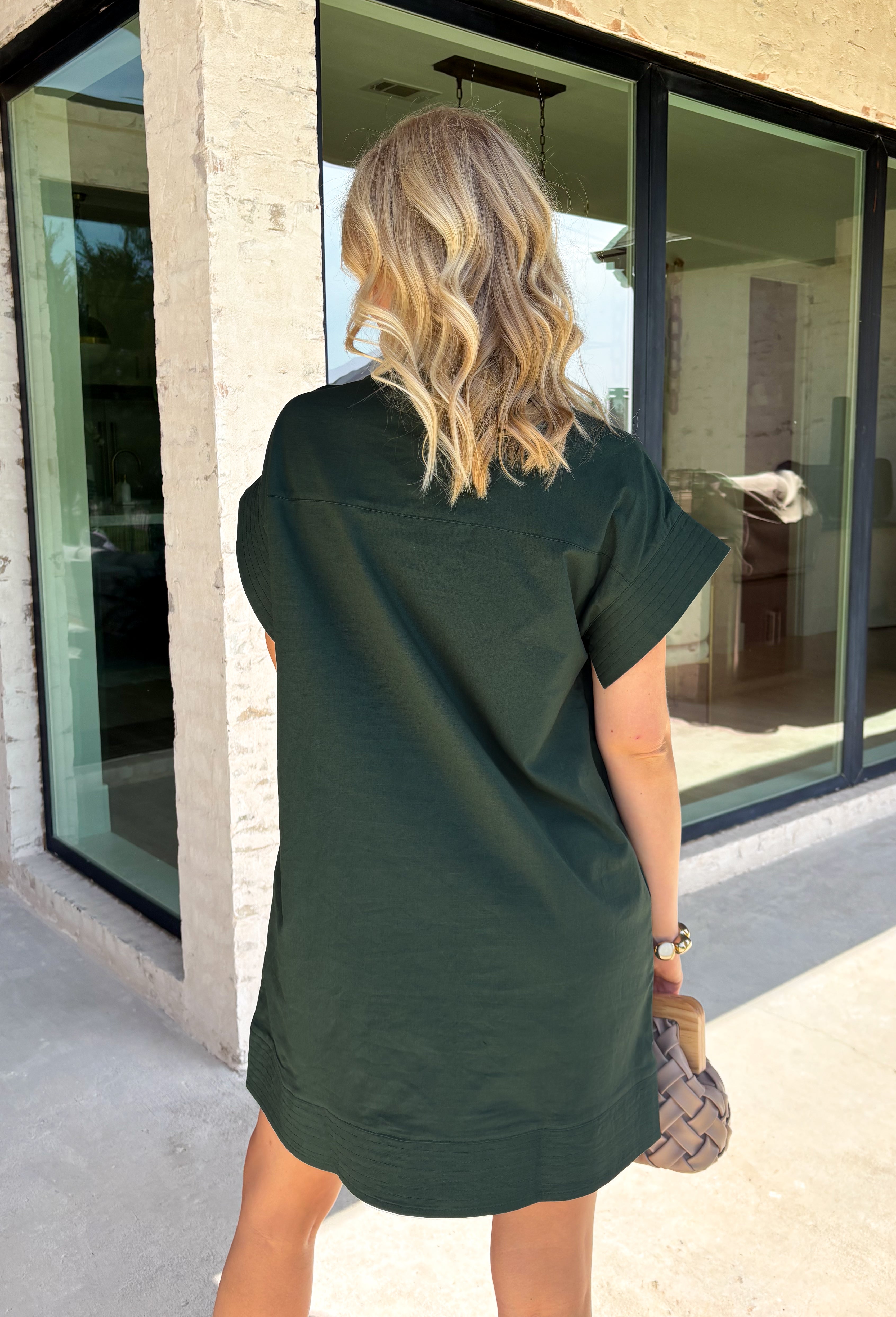 This forest green short sleeve dress is the perfect, effortless piece your fall wardrobe needs! The hidden button down design keeps the look clean and elevated, giving it that easy shirt dress feel you can dress up or down. Whether you're heading to lunch, work, or weekend plans, this dress brings the perfect pop of color. Just add some mules or sneakers and you’re set—don’t miss this one!