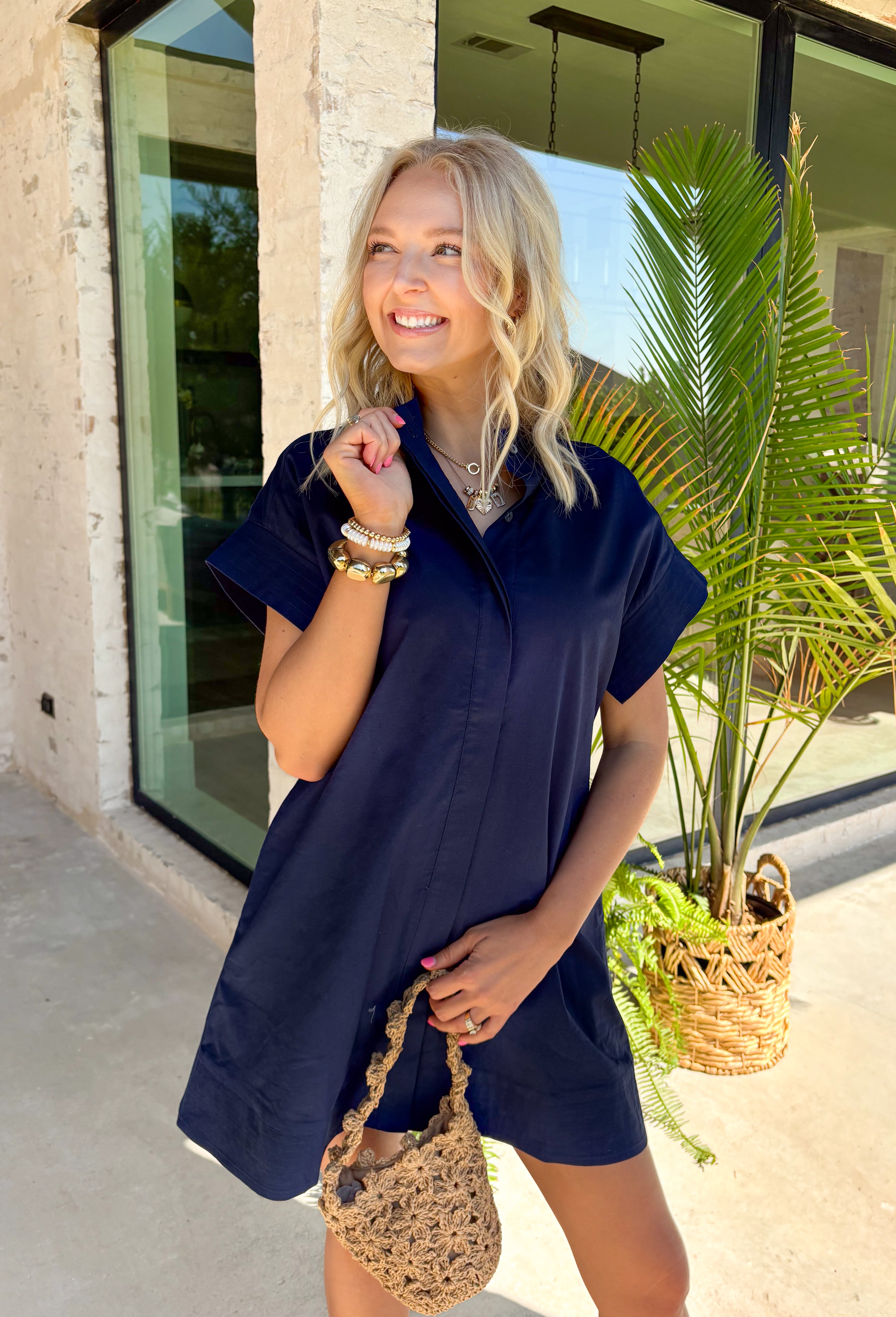 This navy short sleeve dress is the perfect, effortless piece your summer wardrobe needs! Made from a breathable cotton-linen blend, it’s lightweight and perfect for staying cool while still looking put together. The hidden button down design keeps the look clean and elevated, giving it that easy shirt dress feel you can dress up or down. Whether you're heading to lunch, work, or weekend plans, this dress brings the perfect pop of color. Just add sandals or sneakers and you’re set—don’t miss this one!