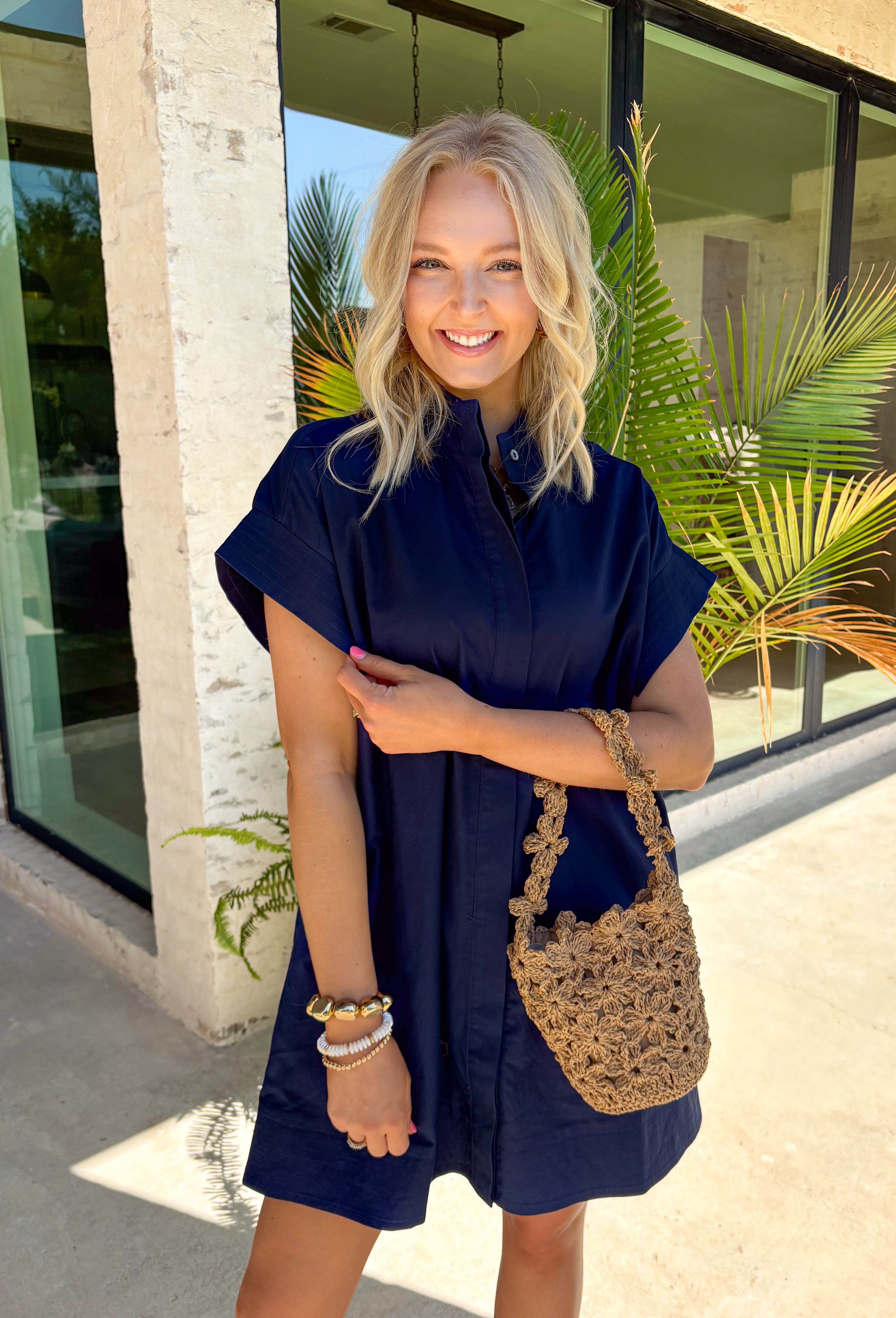 This navy short sleeve dress is the perfect, effortless piece your summer wardrobe needs! Made from a breathable cotton-linen blend, it’s lightweight and perfect for staying cool while still looking put together. The hidden button down design keeps the look clean and elevated, giving it that easy shirt dress feel you can dress up or down. Whether you're heading to lunch, work, or weekend plans, this dress brings the perfect pop of color. Just add sandals or sneakers and you’re set—don’t miss this one!