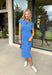 This blue short sleeve midi dress is the kind of effortless piece that makes summer styling so easy! Made from lightweight, breathable cotton, it’s perfect for warm days when you want to feel comfortable but still look put together. The tie details at each hip add a flattering, adjustable touch that gives shape while keeping things relaxed. With its easy midi length and throw-on-and-go feel, this is the dress you’ll reach for on repeat—from casual days to dinner plans. 
