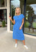 This blue short sleeve midi dress is the kind of effortless piece that makes summer styling so easy! Made from lightweight, breathable cotton, it’s perfect for warm days when you want to feel comfortable but still look put together. The tie details at each hip add a flattering, adjustable touch that gives shape while keeping things relaxed. With its easy midi length and throw-on-and-go feel, this is the dress you’ll reach for on repeat—from casual days to dinner plans. 