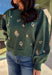 This hunter green sweater by Entro brings cozy charm with a touch of detail. The neutral floral embroidery adds soft texture, while the scalloped neckline and hem give it a sweet, feminine finish. Perfect for cool-weather days, this lightweight knit offers that just-right blend of comfort and style for any fall occasion.