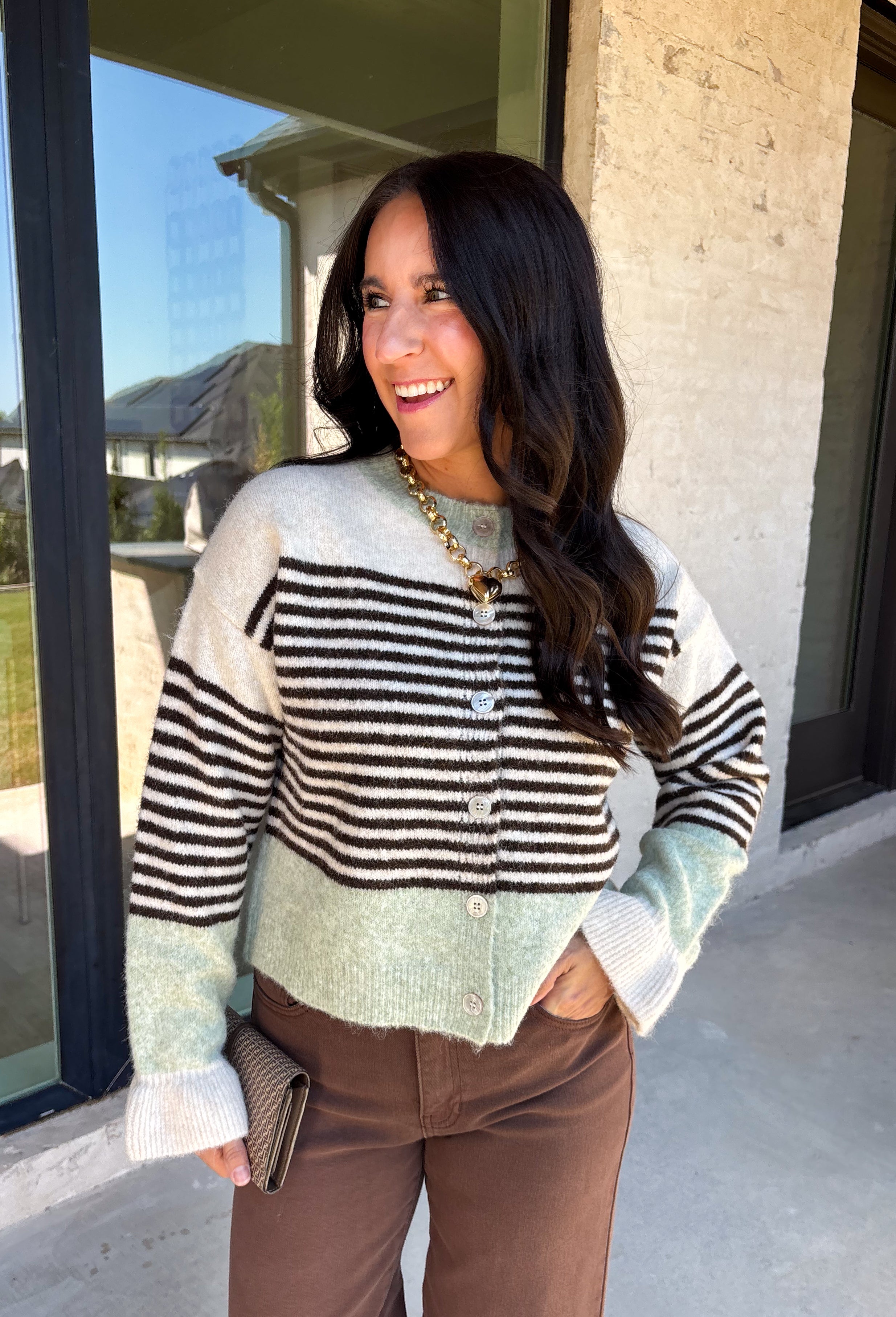 Wrap yourself in cozy comfort with this charming cardigan from Entro. Designed with a soft ecru knit and classic brown stripes, this timeless sweater gets a fresh pop of color from mint trim along the neckline, hem, and cuffs. The button-front design makes it easy to wear open over your favorite basics or buttoned up as a sweater, while the ultra-soft knit blend keeps you warm and comfortable all season long. 