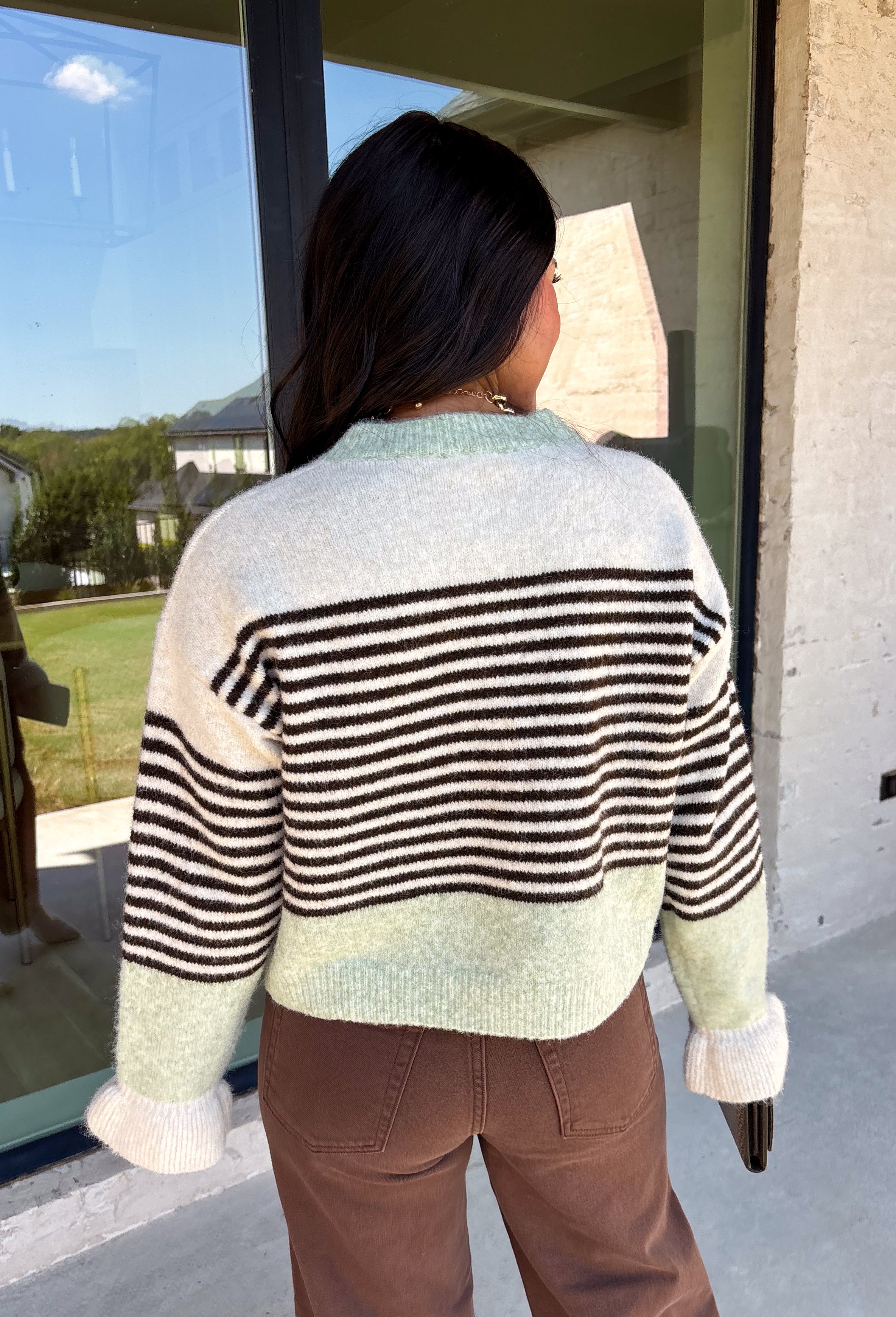 Wrap yourself in cozy comfort with this charming cardigan from Entro. Designed with a soft ecru knit and classic brown stripes, this timeless sweater gets a fresh pop of color from mint trim along the neckline, hem, and cuffs. The button-front design makes it easy to wear open over your favorite basics or buttoned up as a sweater, while the ultra-soft knit blend keeps you warm and comfortable all season long. 
