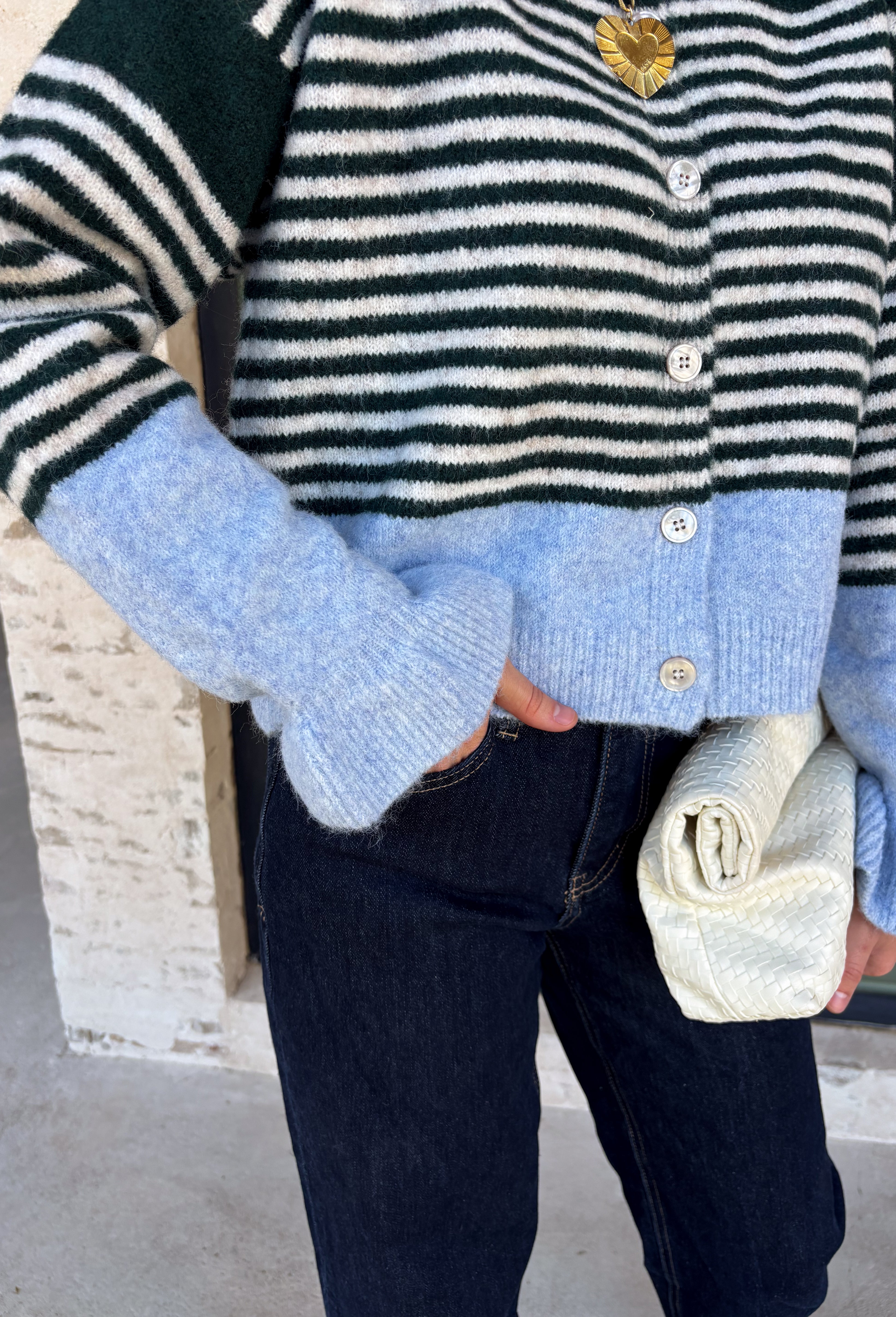 Wrap yourself in cozy comfort with this charming cardigan from Entro. Designed with a soft hunter knit and classic off white stripes, this timeless sweater gets a fresh pop of color from a light blue trim along the neckline, hem, and cuffs. The button-front design makes it easy to wear open over your favorite basics or buttoned up as a sweater, while the ultra-soft knit blend keeps you warm and comfortable all season long. 
