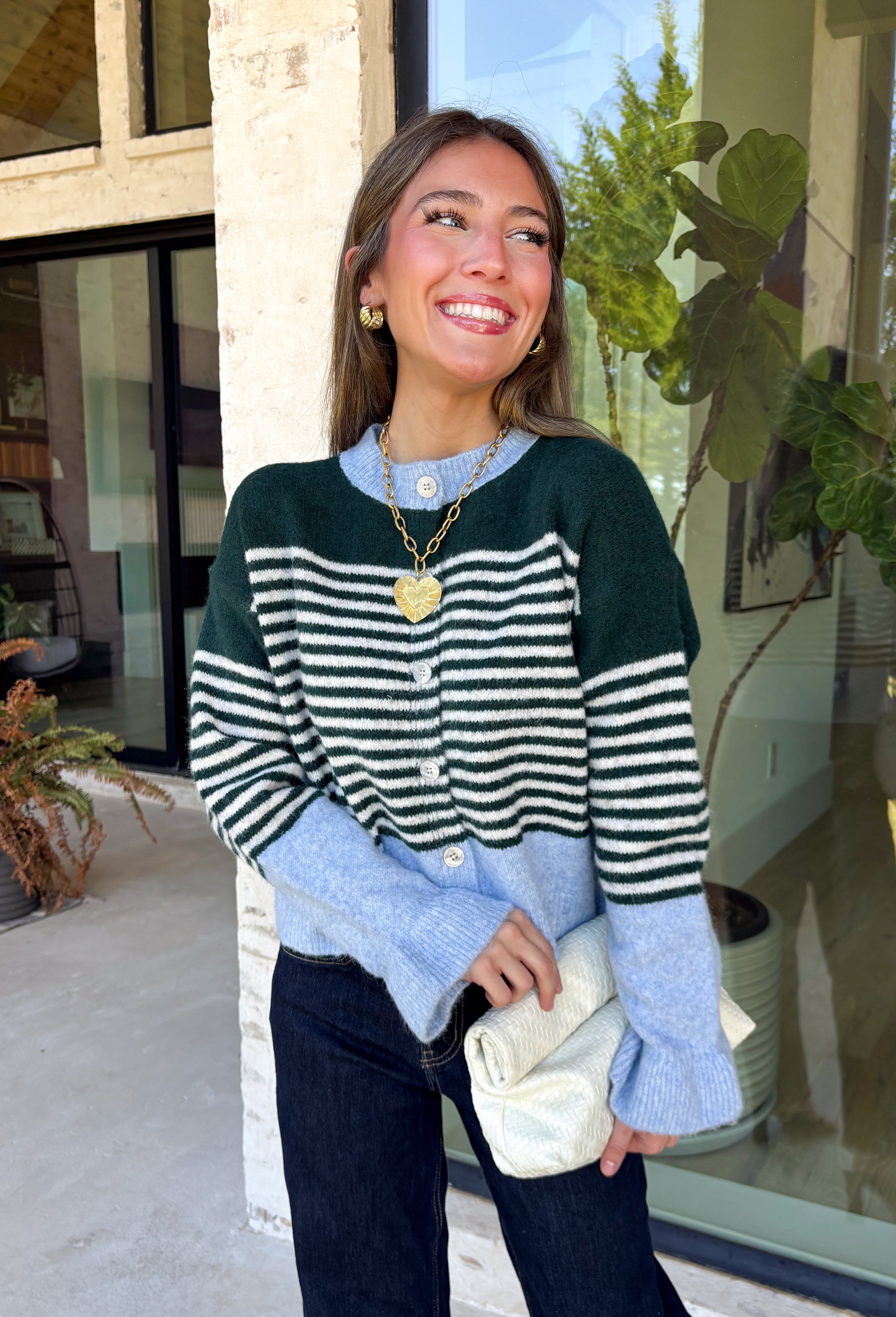 Wrap yourself in cozy comfort with this charming cardigan from Entro. Designed with a soft hunter knit and classic off white stripes, this timeless sweater gets a fresh pop of color from a light blue trim along the neckline, hem, and cuffs. The button-front design makes it easy to wear open over your favorite basics or buttoned up as a sweater, while the ultra-soft knit blend keeps you warm and comfortable all season long. 