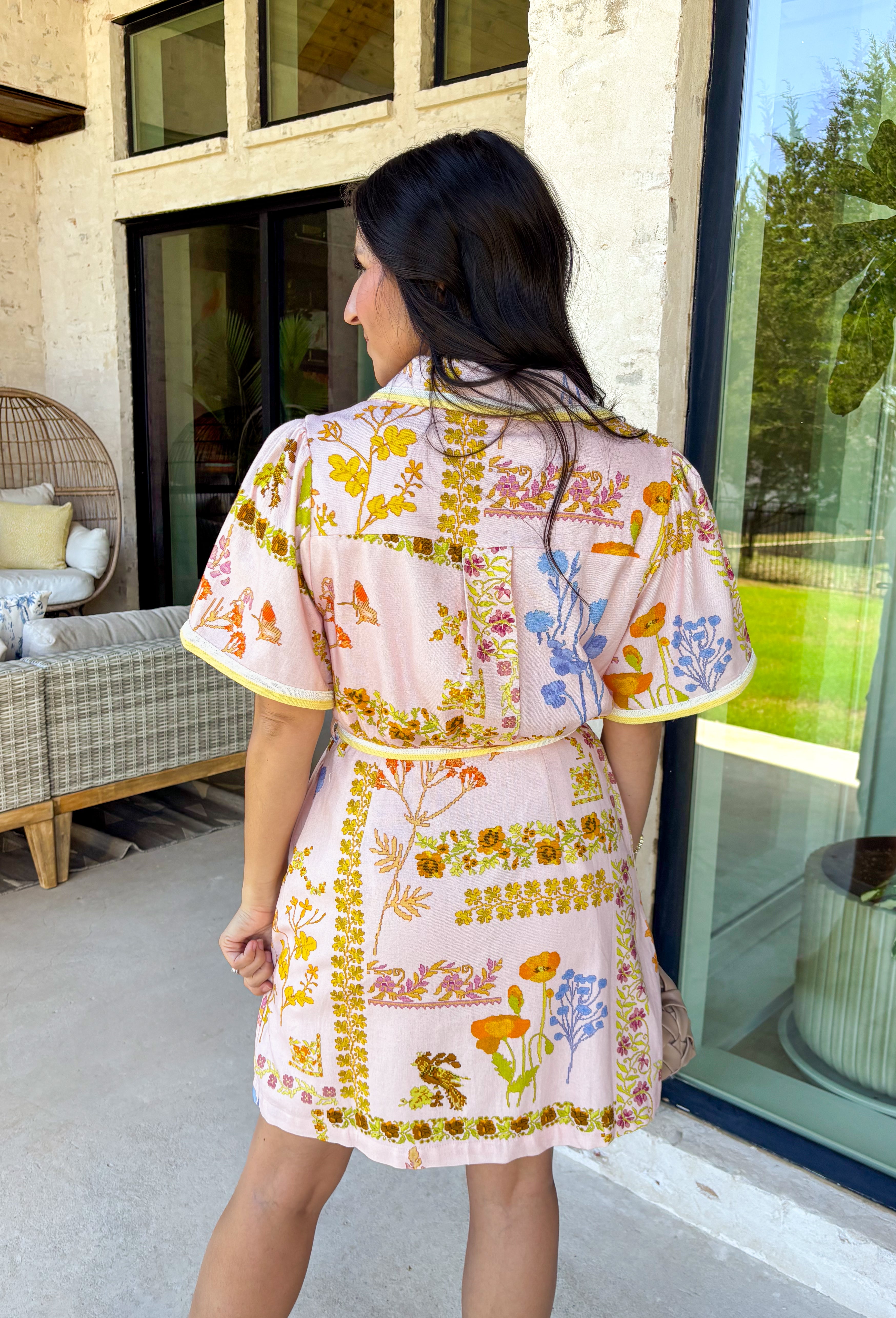 Say hello to sunshine-ready style! This light pink button down dress by &Merci is the kind of piece that instantly brightens your closet. Covered in a cheerful floral print with shades of blue, orange, and yellow, it feels fresh, feminine, and made for spring days ahead. Light yellow and white accent trim adds the sweetest contrast along the collared neckline and sleeve cuffs, tying in perfectly with the matching self-tie belt that cinches the waist for a flattering, easy fit. 