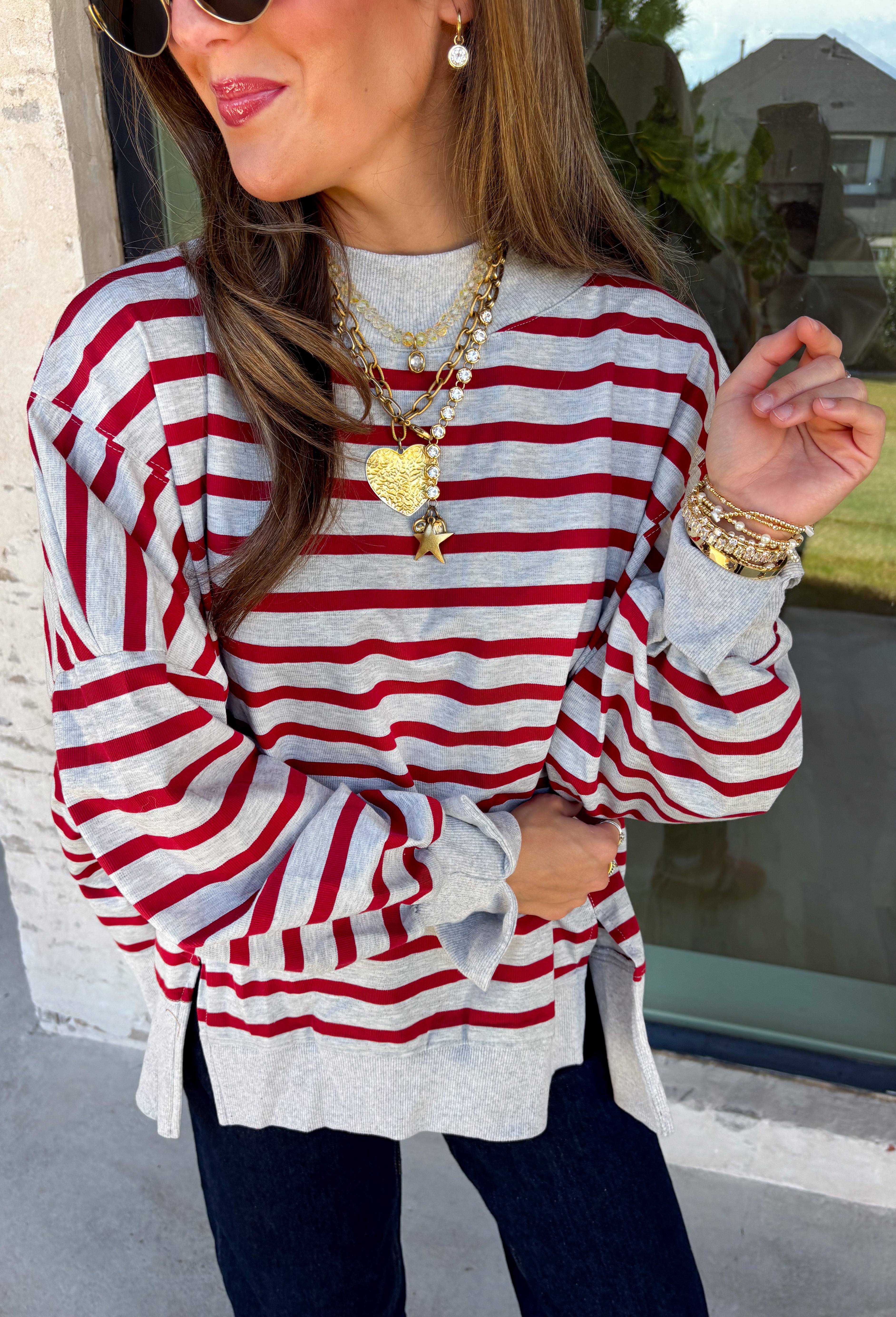 Easy layers are a must as fall starts turning into winter, and this lightweight pullover from Hyfve fits right into the season. The heather grey base is paired with dark red stripes for a cozy color combination that feels especially fitting as the holidays get closer. A mock neckline adds a little extra coverage without making the pullover feel too heavy, making it perfect for those in-between weather days. The soft fabric blend has a touch of stretch for comfortable all-day wear.