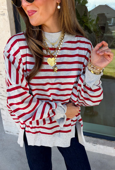 Easy layers are a must as fall starts turning into winter, and this lightweight pullover from Hyfve fits right into the season. The heather grey base is paired with dark red stripes for a cozy color combination that feels especially fitting as the holidays get closer. A mock neckline adds a little extra coverage without making the pullover feel too heavy, making it perfect for those in-between weather days. The soft fabric blend has a touch of stretch for comfortable all-day wear.