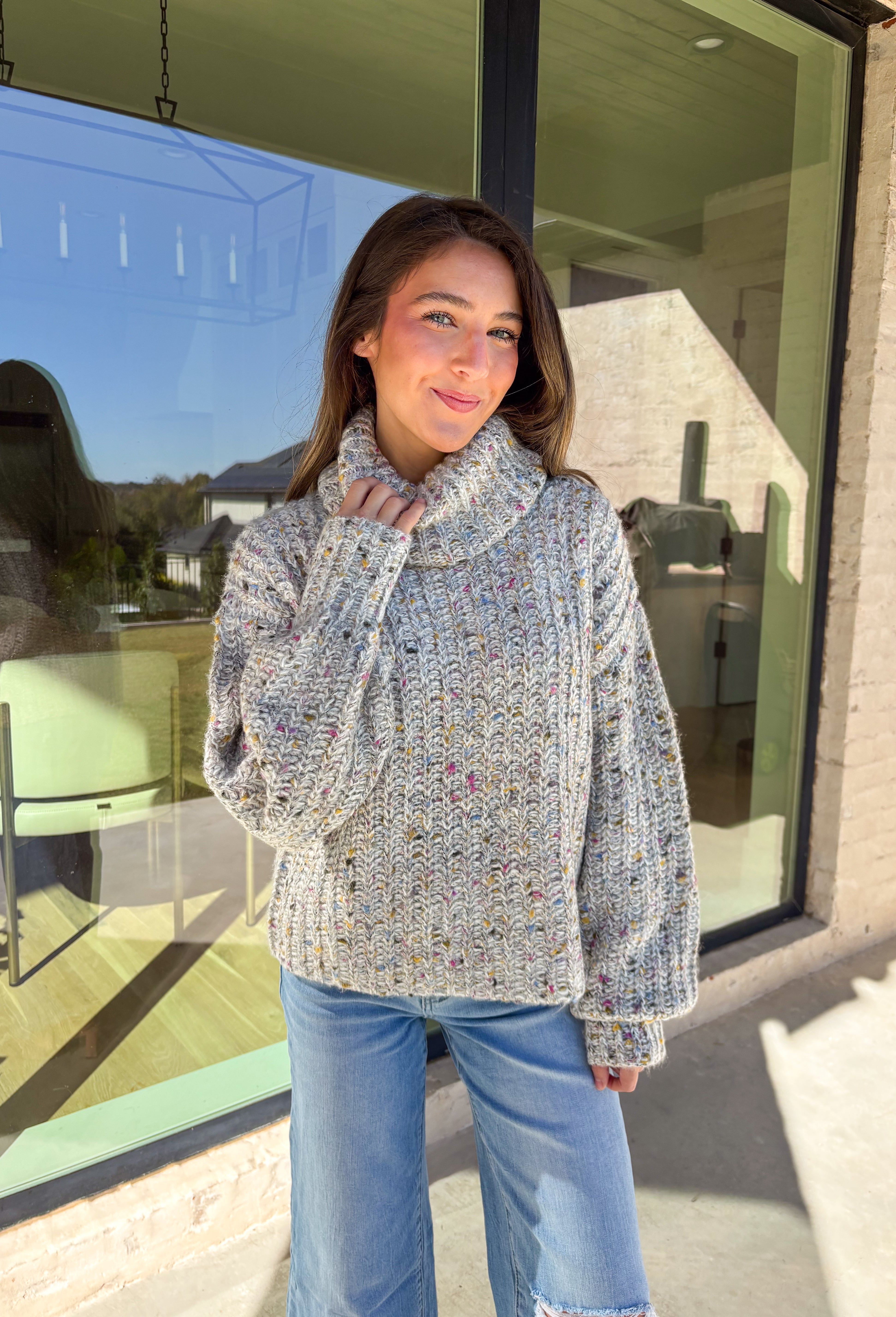 Stay warm and stylish this season in this neutral chunky knit turtleneck sweater by Mystree. Featuring colorful threading woven throughout, this cozy piece brings a playful pop to your winter wardrobe. The thick, soft knit and classic turtleneck design make it perfect for chilly days when you want to look cute and feel comfy.