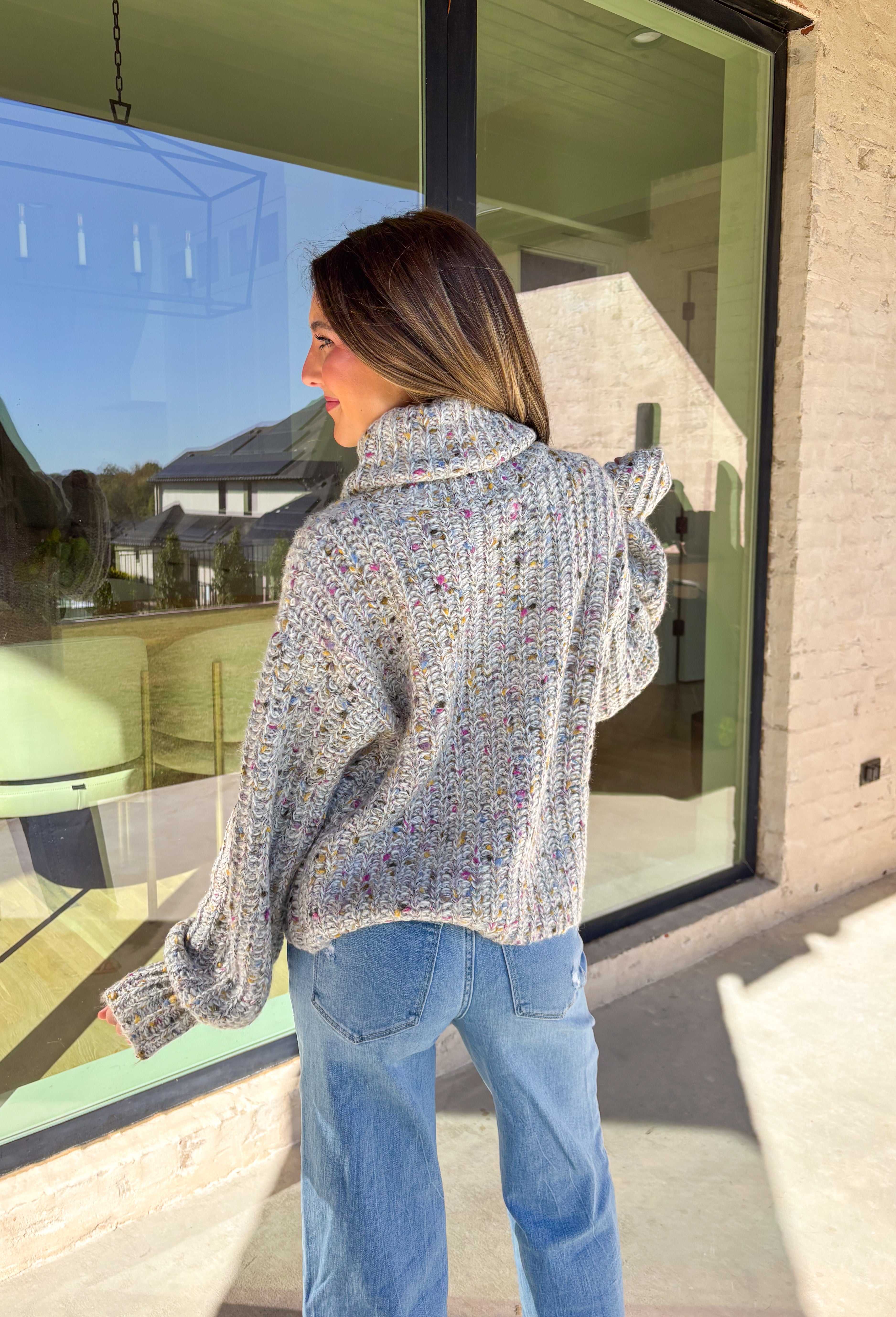 Stay warm and stylish this season in this neutral chunky knit turtleneck sweater by Mystree. Featuring colorful threading woven throughout, this cozy piece brings a playful pop to your winter wardrobe. The thick, soft knit and classic turtleneck design make it perfect for chilly days when you want to look cute and feel comfy.