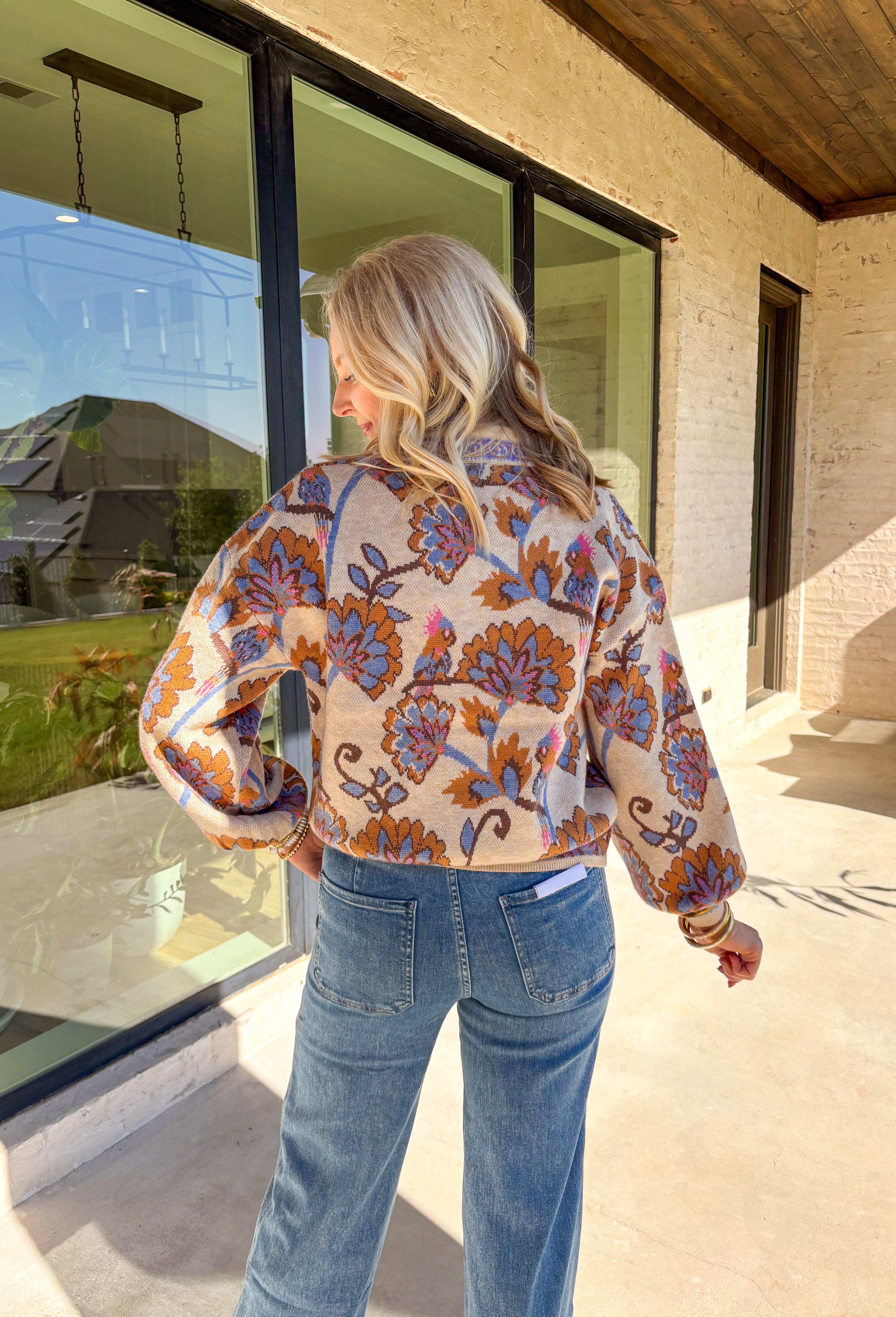 Cozy meets colorful in this tan button-down cardigan. Designed with a floral print in rich shades of periwinkle, purple, pink, and brown, it’s a warm layer that brings instant personality to your fall wardrobe. The long sleeves and soft knit blend keep it extra comfortable, while the button-front closure makes it easy to wear open or closed. Perfect for layering with denim, skirts, or dresses, this cardigan is as versatile as it is charming.