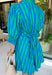 Fresh stripes and easy details make this green and blue dress by Entro a spring must-have. Designed with a striped pattern, it features ¾ length puff sleeves that add a playful, feminine touch. The ruffled band collar and partial button-front closure give it a polished feel, while the self-tie at the back waist creates a flattering, adjustable fit. Fully lined for comfort, this dress is perfect for spring days when you want something effortless, cute, and ready to go.