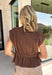 Elevate your everyday wardrobe with this utility-inspired top that perfectly blends style and function. Crafted in a rich chocolate brown hue, this versatile piece features a modern snap button-front with a hidden zipper closure for a polished, elevated look. The elastic waist creates a flattering silhouette while keeping the fit comfortable and easy to wear. 