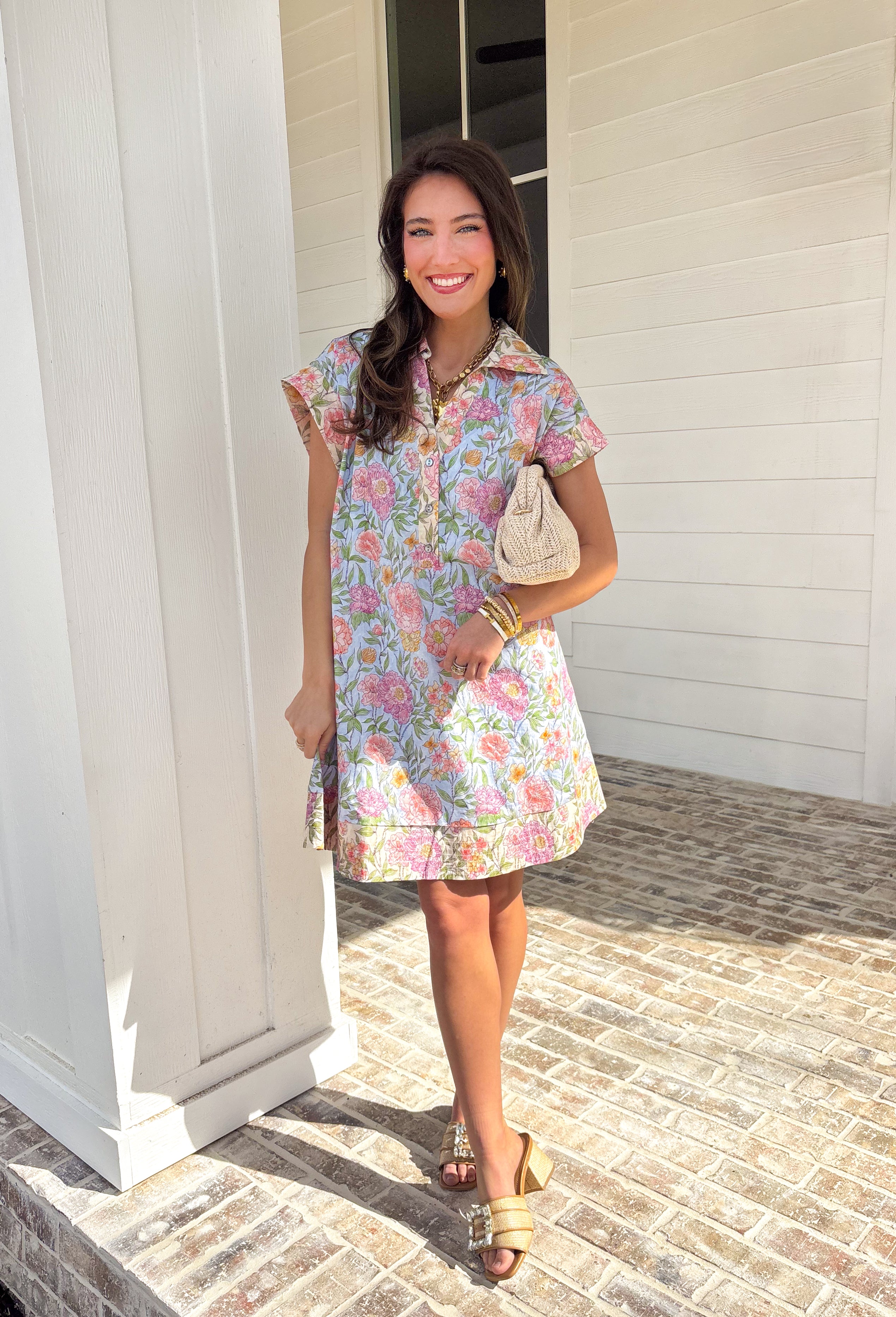 Soft, classic, and full of spring charm, this light blue short sleeve dress by Entro is an easy favorite for the season. Featuring a pastel floral print throughout, it feels light, fresh, and effortlessly pretty. The collared neckline and front button details add a timeless touch, while the fully lined cotton fabric keeps it comfortable and breathable for warm spring days. You'll find yourself reaching for this dress all season long!