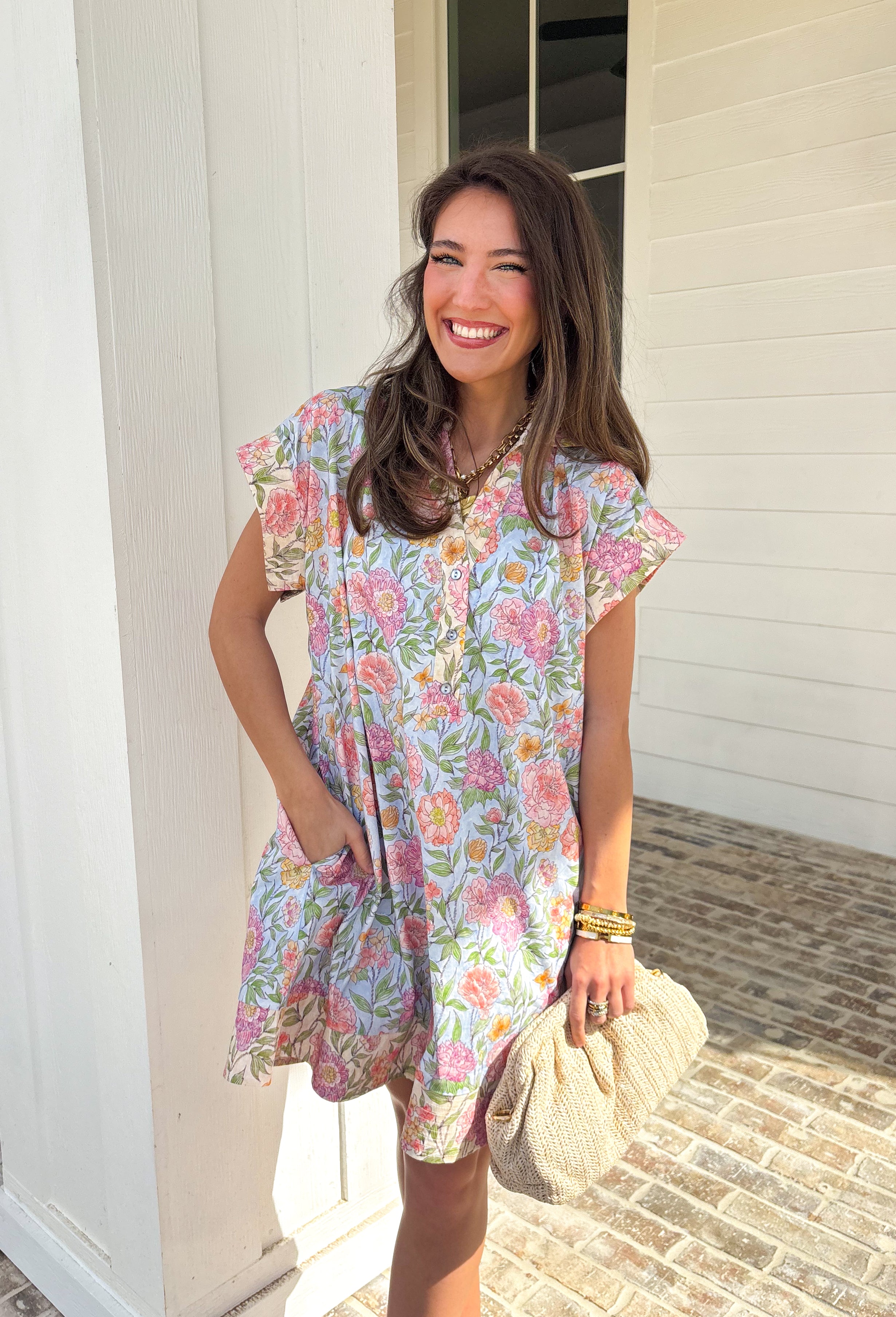 Soft, classic, and full of spring charm, this light blue short sleeve dress by Entro is an easy favorite for the season. Featuring a pastel floral print throughout, it feels light, fresh, and effortlessly pretty. The collared neckline and front button details add a timeless touch, while the fully lined cotton fabric keeps it comfortable and breathable for warm spring days. You'll find yourself reaching for this dress all season long!