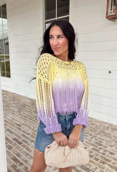Soft, dreamy, and made for sunshine-filled days, this open knit sweater blends butter yellow and light purple in the prettiest ombré effect. The gradual color fade feels light and airy — perfect for bright spring mornings and breezy evenings. The open knit design gives it a breathable, relaxed feel while still offering cozy texture. Crafted from 100% cotton, it’s lightweight enough to layer now and wear on its own as temperatures warm up. 