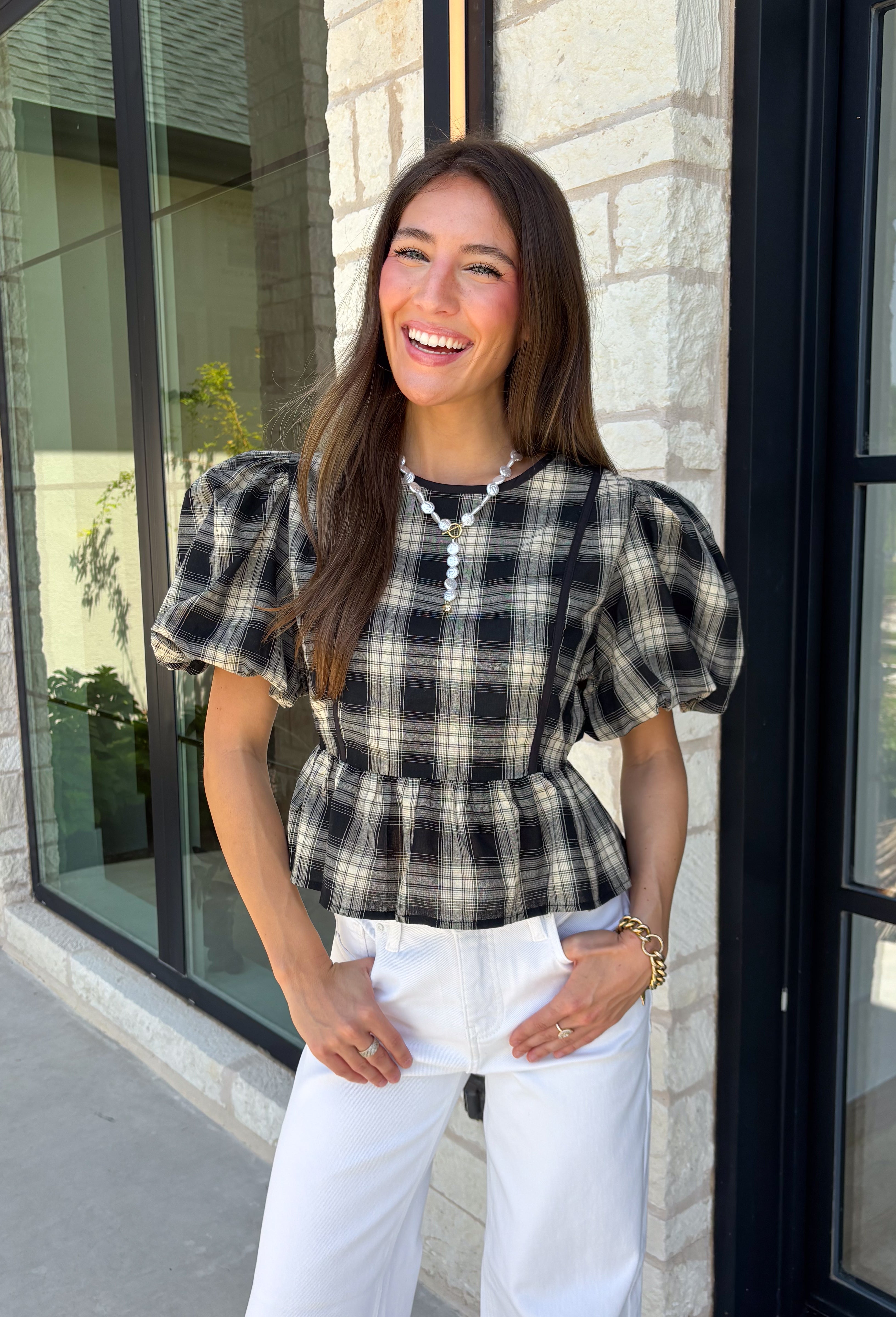 Nothing says fall quite like classic plaid! This black and tan plaid top brings timeless autumn style with a flattering structured babydoll silhouette that's easy to dress up or down. Feminine puff sleeves add a charming touch, while the back zipper closure creates a polished fit. Crafted from a breathable cotton blend, it's the perfect top for everything from pumpkin patch adventures and weekend brunches to casual office days and family gatherings.