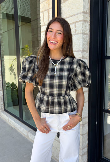 Nothing says fall quite like classic plaid! This black and tan plaid top brings timeless autumn style with a flattering structured babydoll silhouette that's easy to dress up or down. Feminine puff sleeves add a charming touch, while the back zipper closure creates a polished fit. Crafted from a breathable cotton blend, it's the perfect top for everything from pumpkin patch adventures and weekend brunches to casual office days and family gatherings.