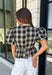 Nothing says fall quite like classic plaid! This black and tan plaid top brings timeless autumn style with a flattering structured babydoll silhouette that's easy to dress up or down. Feminine puff sleeves add a charming touch, while the back zipper closure creates a polished fit. Crafted from a breathable cotton blend, it's the perfect top for everything from pumpkin patch adventures and weekend brunches to casual office days and family gatherings.