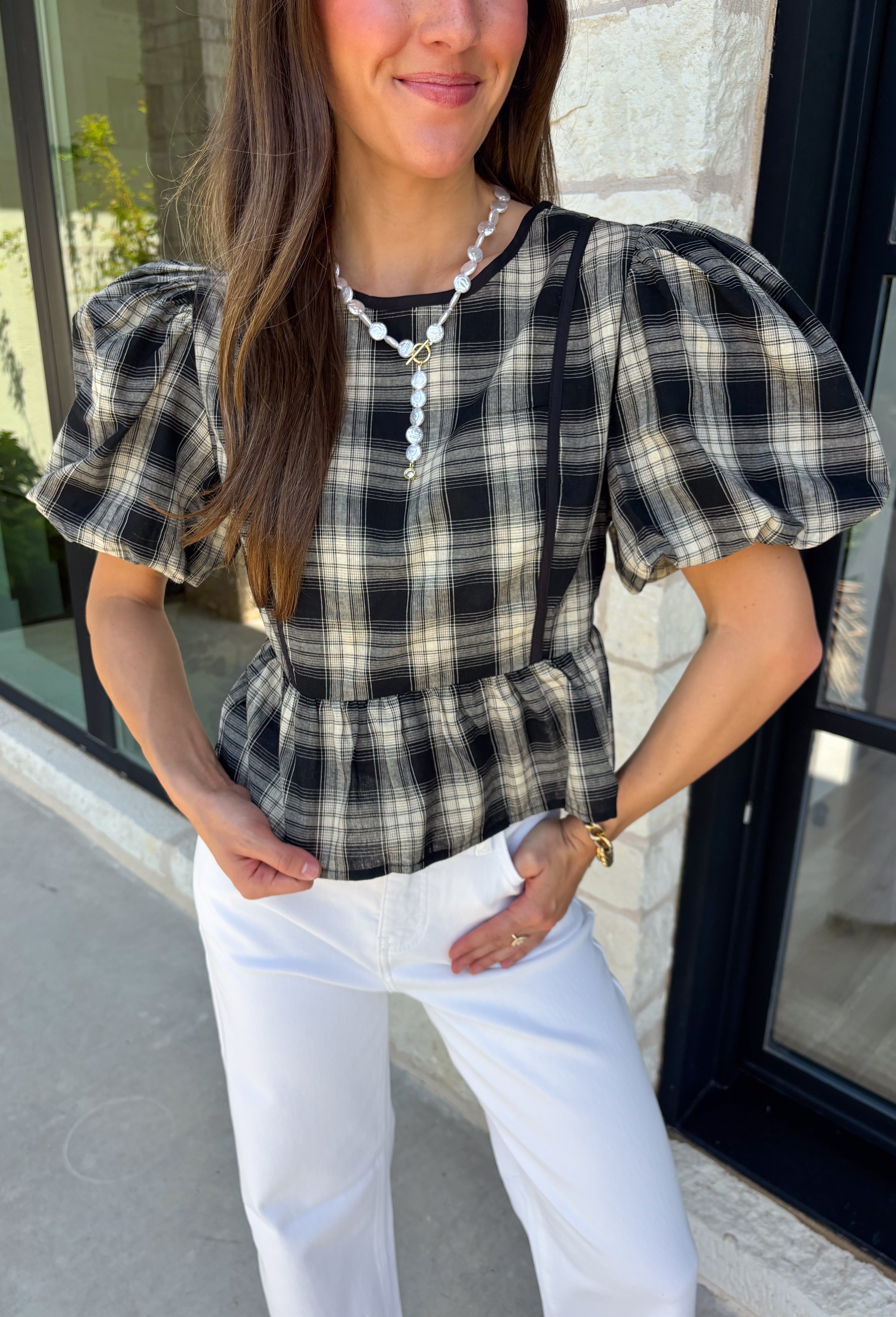 Nothing says fall quite like classic plaid! This black and tan plaid top brings timeless autumn style with a flattering structured babydoll silhouette that's easy to dress up or down. Feminine puff sleeves add a charming touch, while the back zipper closure creates a polished fit. Crafted from a breathable cotton blend, it's the perfect top for everything from pumpkin patch adventures and weekend brunches to casual office days and family gatherings.