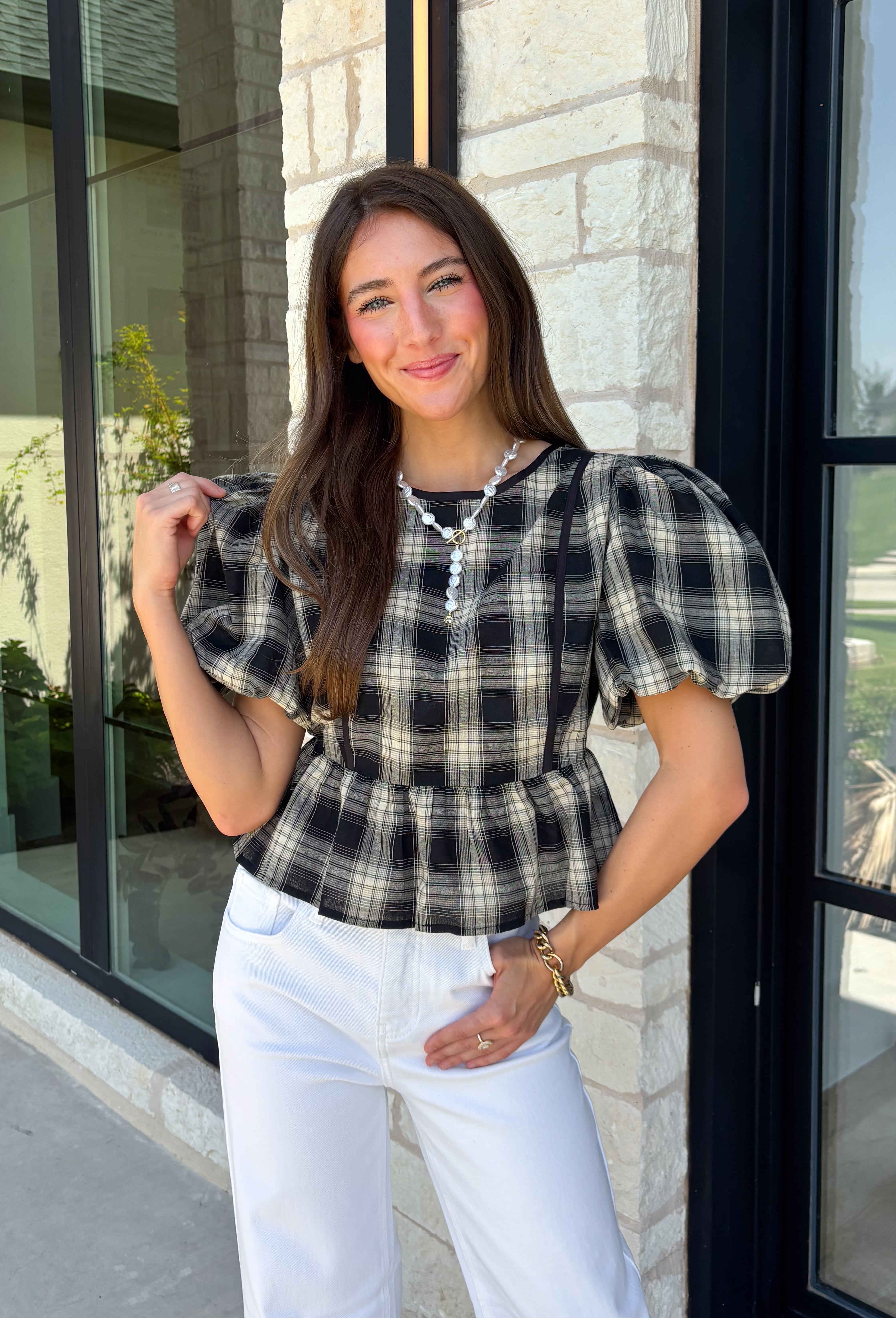 Nothing says fall quite like classic plaid! This black and tan plaid top brings timeless autumn style with a flattering structured babydoll silhouette that's easy to dress up or down. Feminine puff sleeves add a charming touch, while the back zipper closure creates a polished fit. Crafted from a breathable cotton blend, it's the perfect top for everything from pumpkin patch adventures and weekend brunches to casual office days and family gatherings.