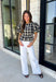 Nothing says fall quite like classic plaid! This black and tan plaid top brings timeless autumn style with a flattering structured babydoll silhouette that's easy to dress up or down. Feminine puff sleeves add a charming touch, while the back zipper closure creates a polished fit. Crafted from a breathable cotton blend, it's the perfect top for everything from pumpkin patch adventures and weekend brunches to casual office days and family gatherings.