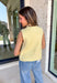 A cheerful pop of color for your fall wardrobe, this butter yellow sweater vest is both cozy and chic. Designed with a button-front closure, each hammered gold button adds a touch of shine and texture against the soft knit. The sleeveless silhouette makes it perfect for layering over blouses, dresses, or turtlenecks, giving you endless styling options as the weather cools. Lightweight with just the right amount of stretch, it’s a versatile piece that will brighten up your seasonal staples.