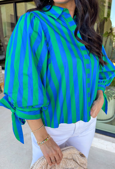 Spring stripes are always a good idea, and this green and blue top by Entro is giving effortless charm in the cutest way. With 3/4 puff sleeves and sweet tie details at the cuffs, it has that polished-but-still-playful look we love for the season. The hidden button-front closure keeps things clean and classic, making it easy to style for workdays, weekends, and everything in between.
