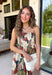 Beautifully feminine and full of rich seasonal color, this floral midi dress is a timeless addition to your fall wardrobe. Designed in a stunning dark teal hue with a gorgeous floral print in warm autumn shades, this dress is perfect for everything from family photos to holiday gatherings. The straight neckline and pleated bodice create an elegant, flattering silhouette, while the adjustable straps and smocked back provide a comfortable, customizable fit. 