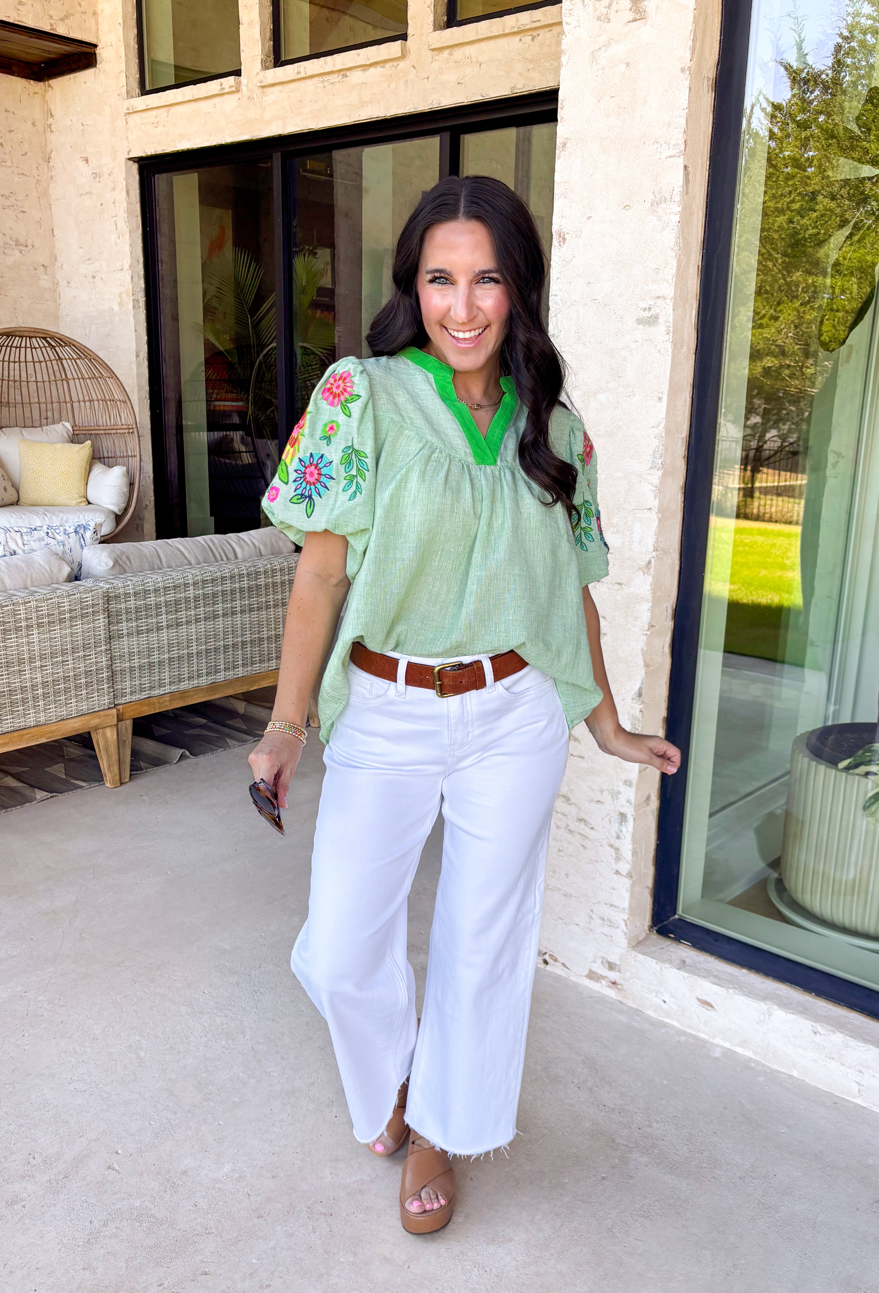 This light green short sleeve top is a true spring standout with its cheerful mix of color and texture. The puff sleeves steal the show with vibrant embroidered details in pink, red, blue, yellow, and green, adding a playful, handcrafted feel that instantly elevates your look. A brighter green contrast trim at the neckline gives it a fresh pop that frames the face beautifully. Lightweight and easy to wear, this top is perfect for bringing a little extra color and personality to your everyday spring outfits.
