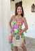 This sleeveless floral dress is bringing all the color and all the confidence. Featuring a bold mix of purple, orange, green, yellow, pink, and white, this beauty is made to stand out in the best way. The scalloped neckline and hem add the sweetest feminine touch, while the fabric-covered knotted bead straps give it that extra detail that feels fun and elevated. Designed with smocking along the back for a comfortable, flattering fit, this fully lined cotton dress is as easy to wear as it is eye-catching. 
