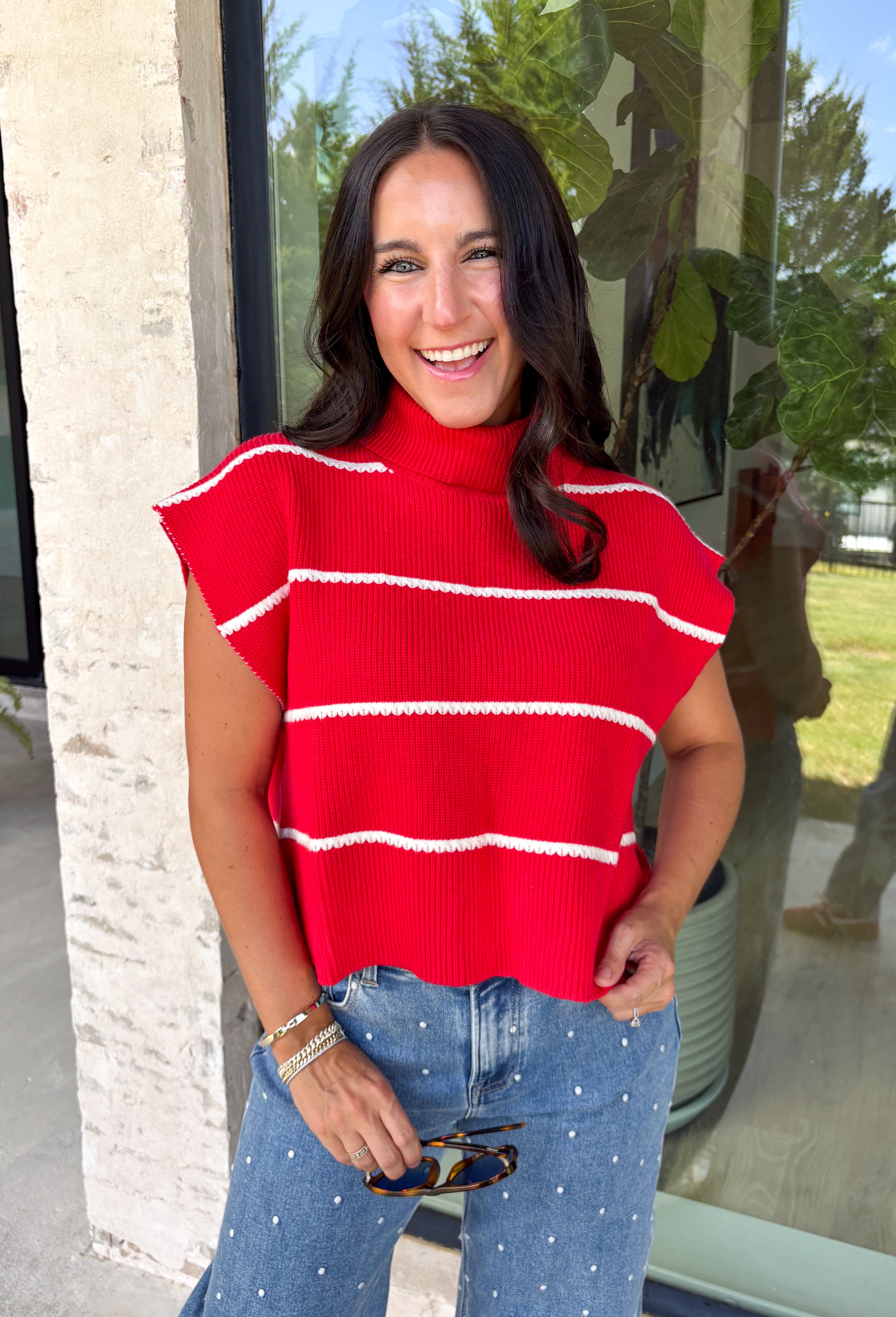 Bring timeless style and cozy comfort to your fall wardrobe with this classic sweater from Day + Moon. Designed in a vibrant red knit with crisp white stripes, this short sleeve sweater is the perfect blend of polished and playful. The cozy turtleneck adds warmth for cooler days, while the soft knit fabric makes it comfortable enough for all-day wear. Whether you're headed to work, a football game, or a weekend coffee date, this versatile sweater is an easy favorite for the season.