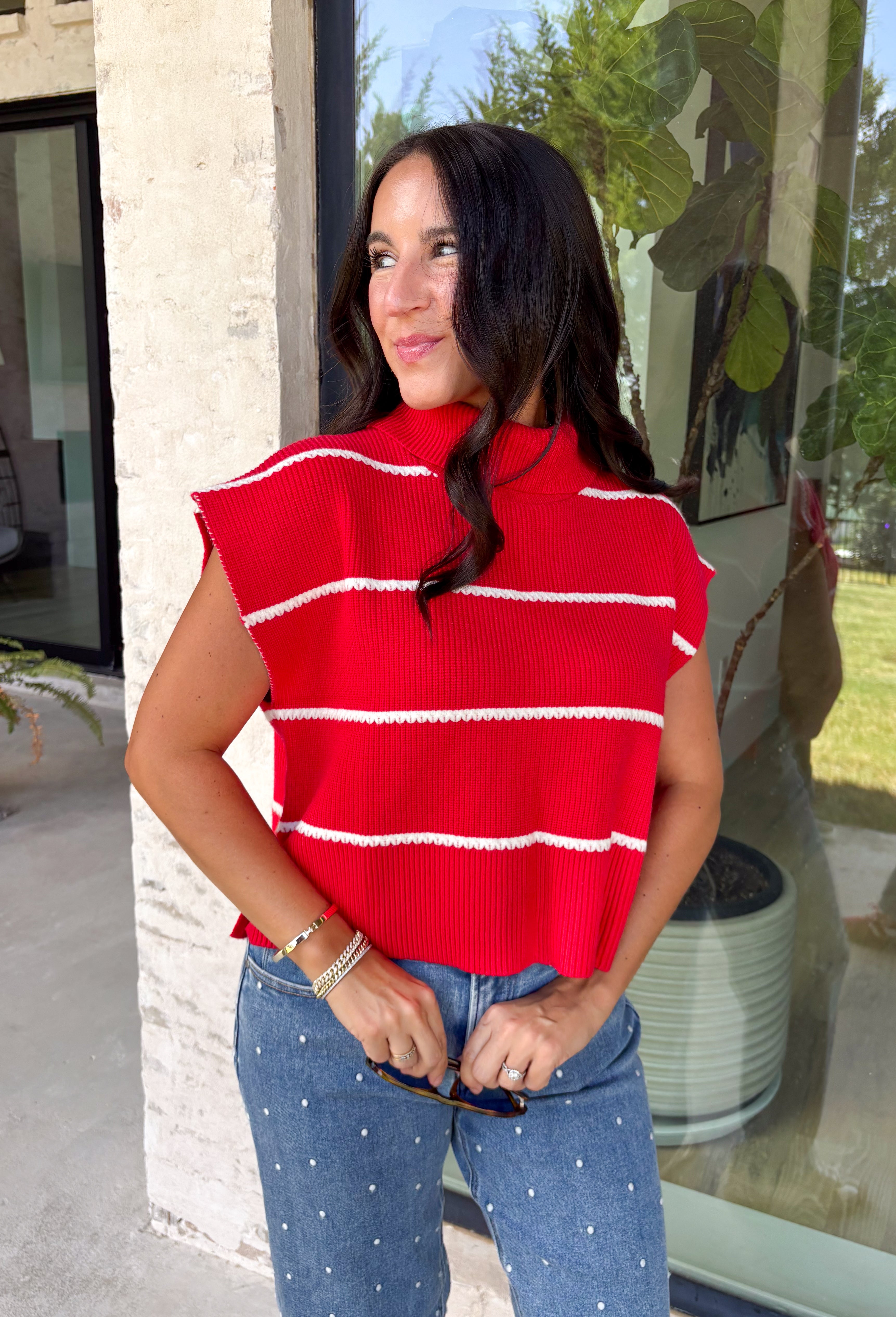 Bring timeless style and cozy comfort to your fall wardrobe with this classic sweater from Day + Moon. Designed in a vibrant red knit with crisp white stripes, this short sleeve sweater is the perfect blend of polished and playful. The cozy turtleneck adds warmth for cooler days, while the soft knit fabric makes it comfortable enough for all-day wear. Whether you're headed to work, a football game, or a weekend coffee date, this versatile sweater is an easy favorite for the season.