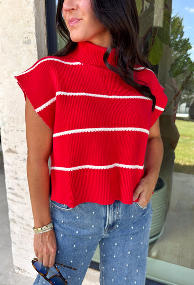 Bring timeless style and cozy comfort to your fall wardrobe with this classic sweater from Day + Moon. Designed in a vibrant red knit with crisp white stripes, this short sleeve sweater is the perfect blend of polished and playful. The cozy turtleneck adds warmth for cooler days, while the soft knit fabric makes it comfortable enough for all-day wear. Whether you're headed to work, a football game, or a weekend coffee date, this versatile sweater is an easy favorite for the season.