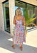 This sleeveless light blue midi dress by Entro is giving major spring picnic energy. With a colorful floral print in pops of red, mustard, and light pink, it’s bright, cheerful, and made for sunny days. The blue and white gingham trim along the top adds the cutest contrast, and the three front tie details bring in that extra sweet, feminine touch we can’t get enough of. 
