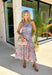 This sleeveless light blue midi dress by Entro is giving major spring picnic energy. With a colorful floral print in pops of red, mustard, and light pink, it’s bright, cheerful, and made for sunny days. The blue and white gingham trim along the top adds the cutest contrast, and the three front tie details bring in that extra sweet, feminine touch we can’t get enough of. 