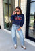 Bring a little extra luck to your cozy season with this playful graphic sweatshirt. Featuring "Lucky" in rust lettering accented with whimsical stars and outlined by a light blue circle, this navy pullover adds the perfect pop of color to your everyday wardrobe. The fleece-lined interior keeps you warm and comfortable, making it the perfect choice for football weekends, coffee runs, casual days, and cozy nights in. It's an easy favorite you'll be reaching for all fall and winter long.
