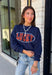 Bring a little extra luck to your cozy season with this playful graphic sweatshirt. Featuring "Lucky" in rust lettering accented with whimsical stars and outlined by a light blue circle, this navy pullover adds the perfect pop of color to your everyday wardrobe. The fleece-lined interior keeps you warm and comfortable, making it the perfect choice for football weekends, coffee runs, casual days, and cozy nights in. It's an easy favorite you'll be reaching for all fall and winter long.