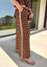 Make a statement from the bottom up with these brown and cream polka dot pants from Entro. The warm brown background paired with classic cream polka dots gives them a playful look that still works beautifully with your favorite fall neutrals. An elasticated waist with a self-tie keeps the fit comfortable and adjustable, while contrast trim along the sides adds an unexpected finishing touch. 