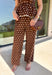 Make a statement from the bottom up with these brown and cream polka dot pants from Entro. The warm brown background paired with classic cream polka dots gives them a playful look that still works beautifully with your favorite fall neutrals. An elasticated waist with a self-tie keeps the fit comfortable and adjustable, while contrast trim along the sides adds an unexpected finishing touch. 