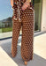 Make a statement from the bottom up with these brown and cream polka dot pants from Entro. The warm brown background paired with classic cream polka dots gives them a playful look that still works beautifully with your favorite fall neutrals. An elasticated waist with a self-tie keeps the fit comfortable and adjustable, while contrast trim along the sides adds an unexpected finishing touch. 